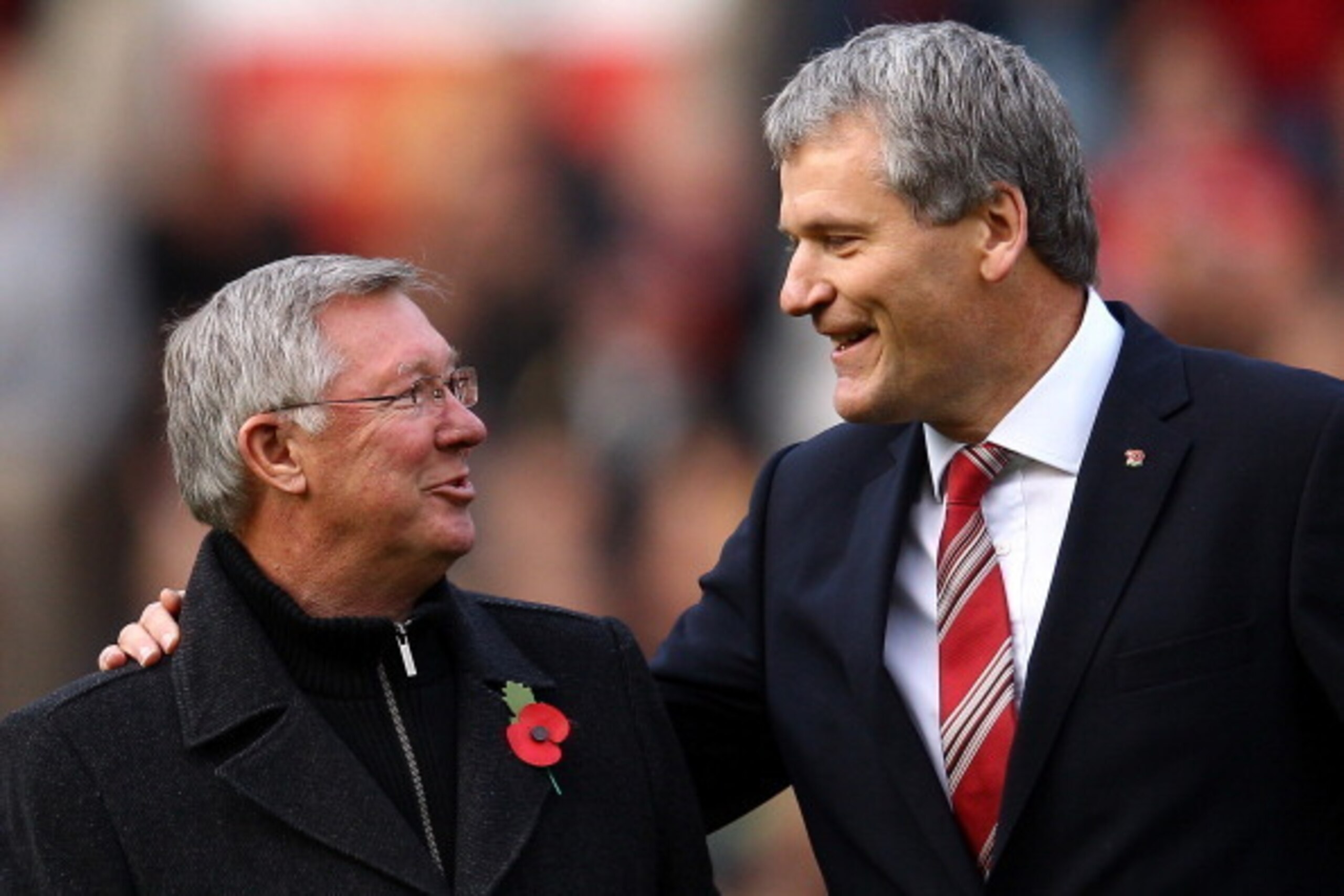 MANCHESTER, ENGLAND - NOVEMBER 05:  Chief Executive David Gill (r) announces the name changing of the North Stand to the 'Sir Alex Ferguson Stand' to commemerate Sir Alex's 25th year as Manager during the Barclays Premier League match between Manchester U
