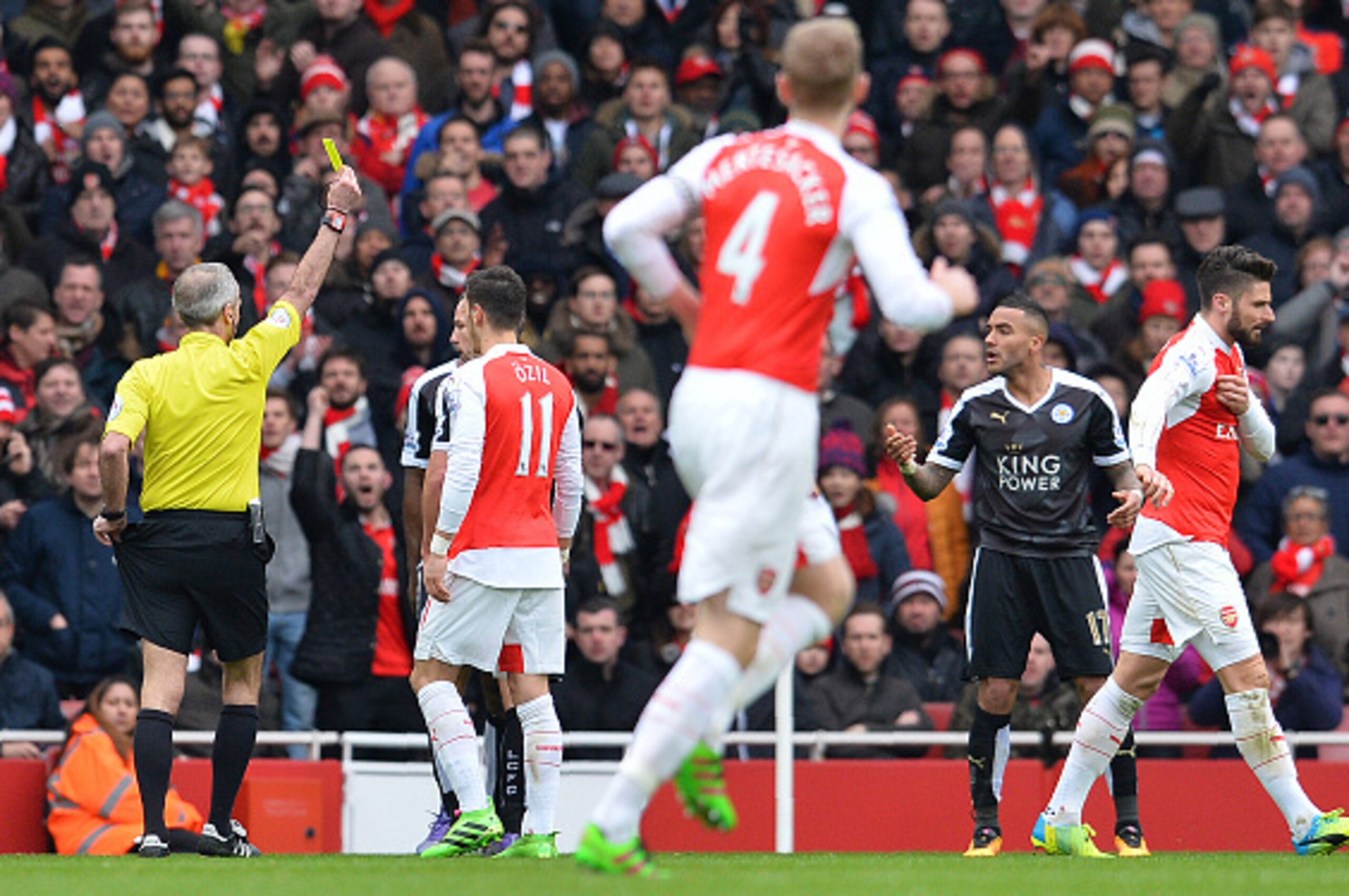 Leicester City's English defender Danny Simpson (R) reacts as referee Martin Atkinson shows him his second yellow card during the English Premier League football match between Arsenal and Leicester at the Emirates Stadium in London on February 14, 2016.  