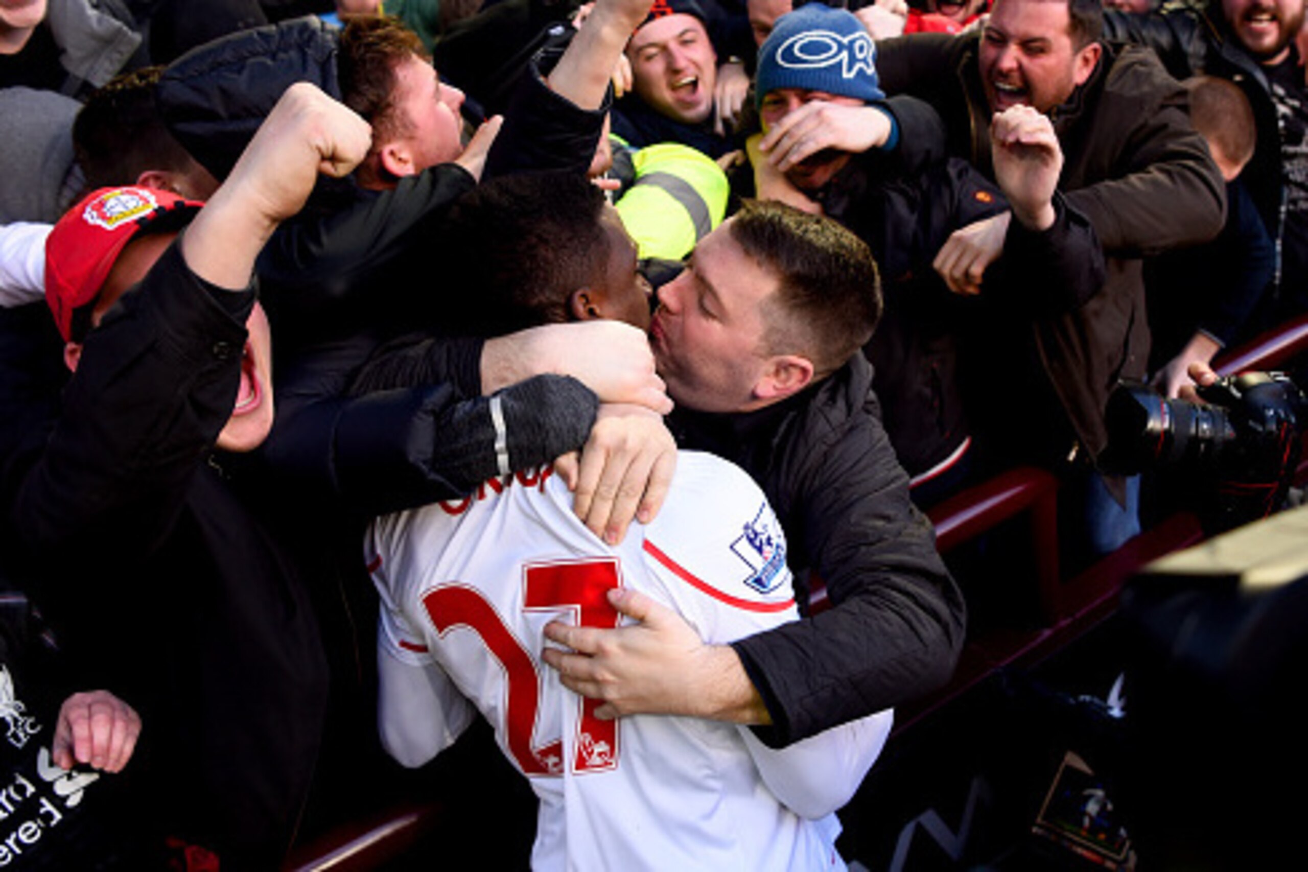 BIRMINGHAM, ENGLAND - FEBRUARY 14:  A Liverpool fan kisses Divock Origi of Liverpool as he celebrates after scoring his team's fourth goal during the Barclays Premier League match between Aston Villa and Liverpool at Villa Park on February 14, 2016 in Bir