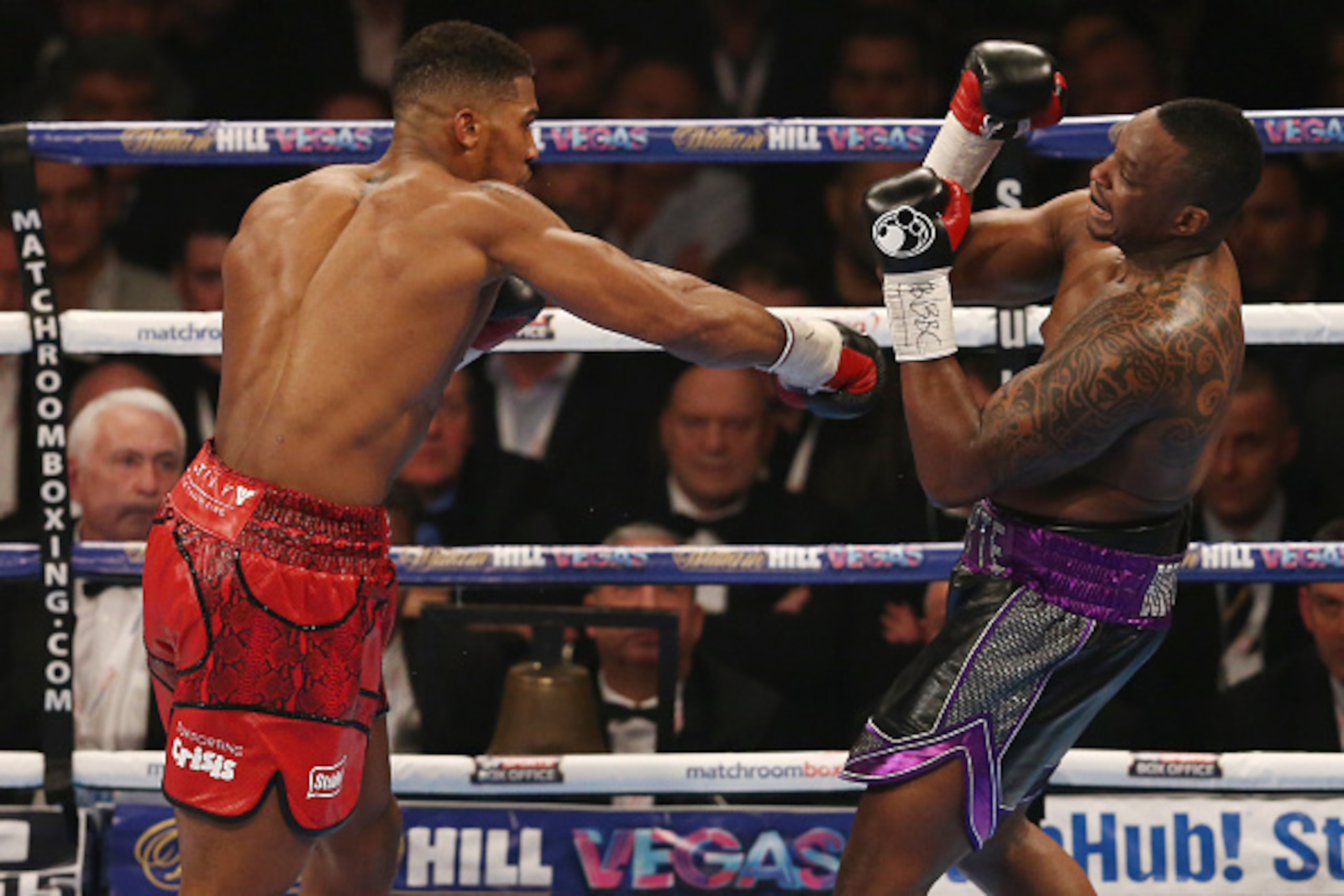 British boxer Anthony Joshua (L) vies against British boxer Dillian Whyte during their British and Commonwealth heavyweight title boxing match at the O2 arena in London on December 12, 2015. AFP PHOTO / JUSTIN TALLIS / AFP / JUSTIN TALLIS        (Photo cr
