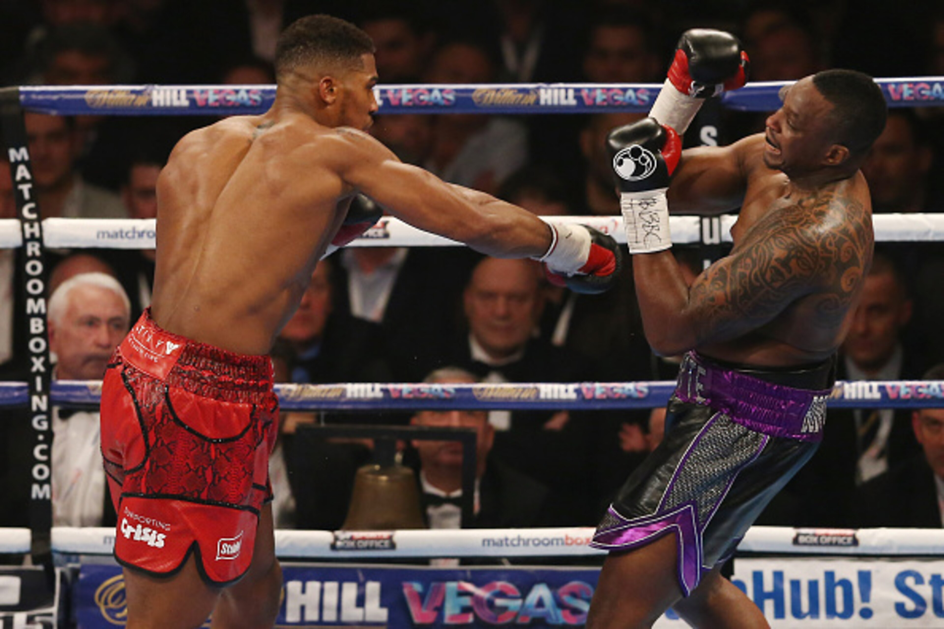 British boxer Anthony Joshua (L) vies against British boxer Dillian Whyte during their British and Commonwealth heavyweight title boxing match at the O2 arena in London on December 12, 2015. AFP PHOTO / JUSTIN TALLIS / AFP / JUSTIN TALLIS        (Photo cr
