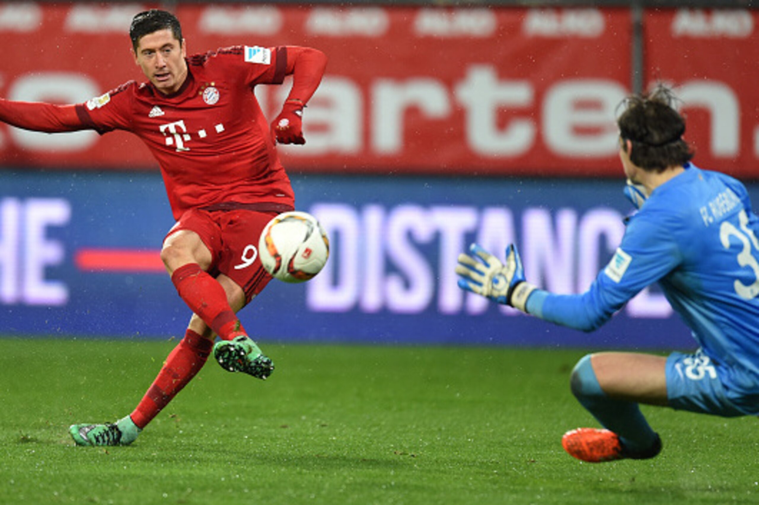 Bayern Munich's Polish striker Robert Lewandowski (L) scores the second goal for Munich past Augsburg's Swiss goalkeeper Marwin Hitz during the German first division Bundesliga football match of FC Augsburg vs FC Bayern Munich in Augsburg, southern German Bayern Munich's Polish striker Robert Lewandowski (L) scores the second goal for Munich past Augsburg's Swiss goalkeeper Marwin Hitz during the German first division Bundesliga football match of FC Augsburg vs FC Bayern Munich in Augsburg, southern German