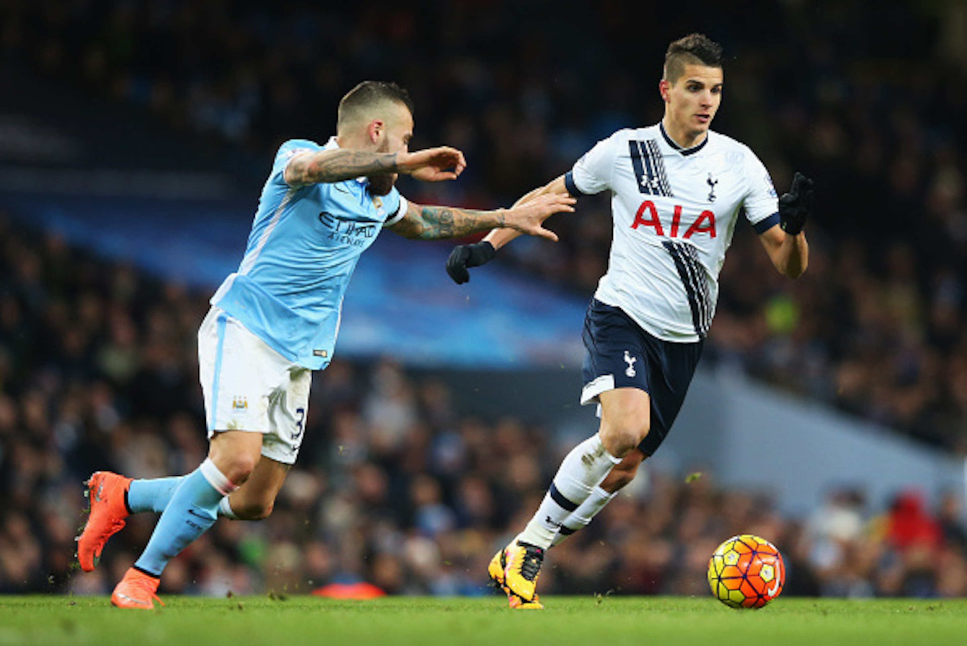 MANCHESTER, ENGLAND - FEBRUARY 14:  Erik Lamela of Tottenham Hotspur goes past Nicolas Otamendi of Manchester City during the Barclays Premier League match between Manchester City and Tottenham Hotspur at Etihad Stadium on February 14, 2016 in Manchester,