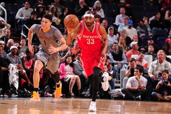 PHOENIX, AZ - FEBRUARY 4: Corey Brewer #33 of the Houston Rockets brings the ball up court against the Phoenix Suns on February 4, 2016, at Talking Stick Resort Arena in Phoenix, Arizona. NOTE TO USER: User expressly acknowledges and agrees that, by downl