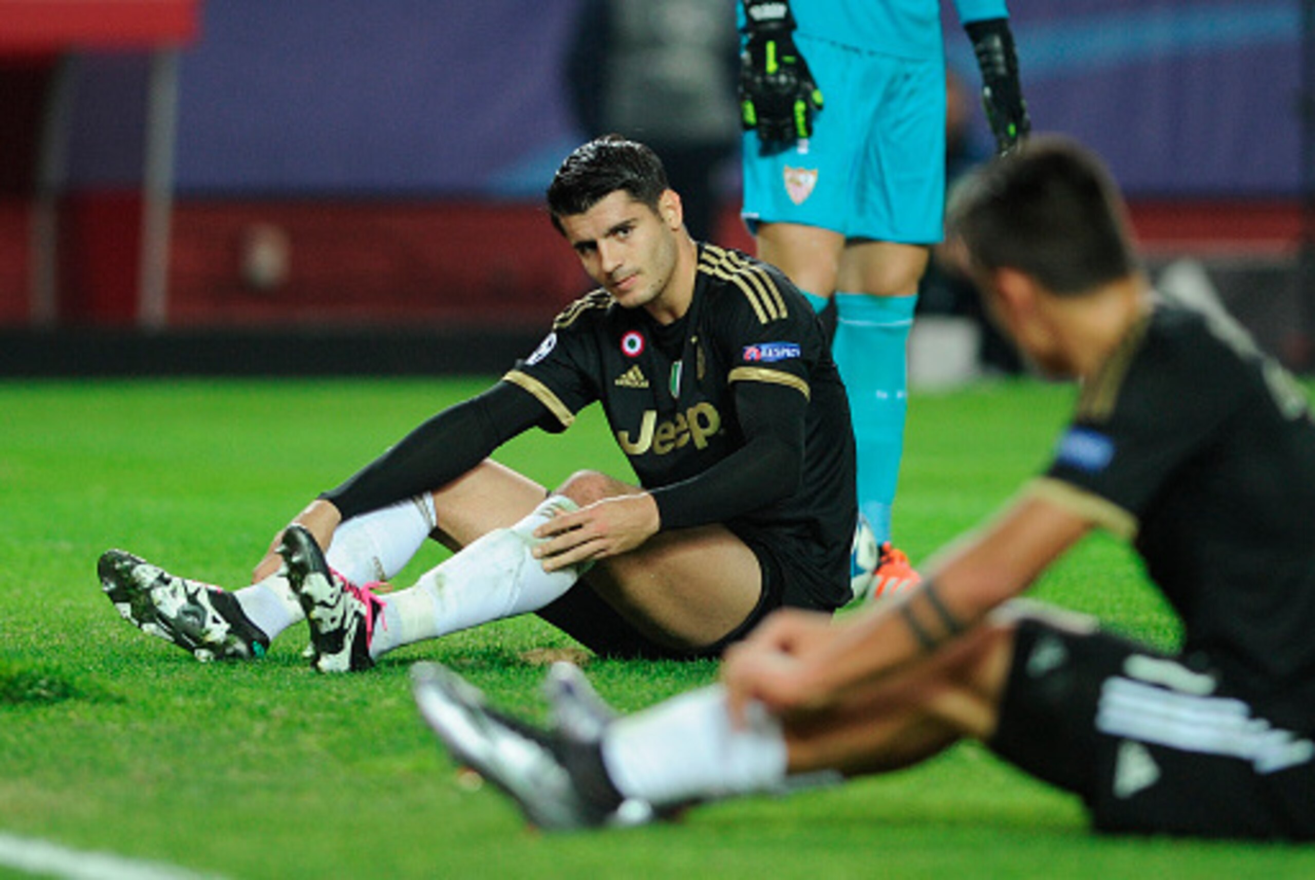 Juventus' Spanish forward Alvaro Morata (L) reacts after missing a goal opportunity during the UEFA Champions League Group D football match Sevilla FC vs Juventus at the Ramon Sanchez Pizjuan stadium in Sevilla on December 8, 2015.   AFP PHOTO/ CRISTINA Q