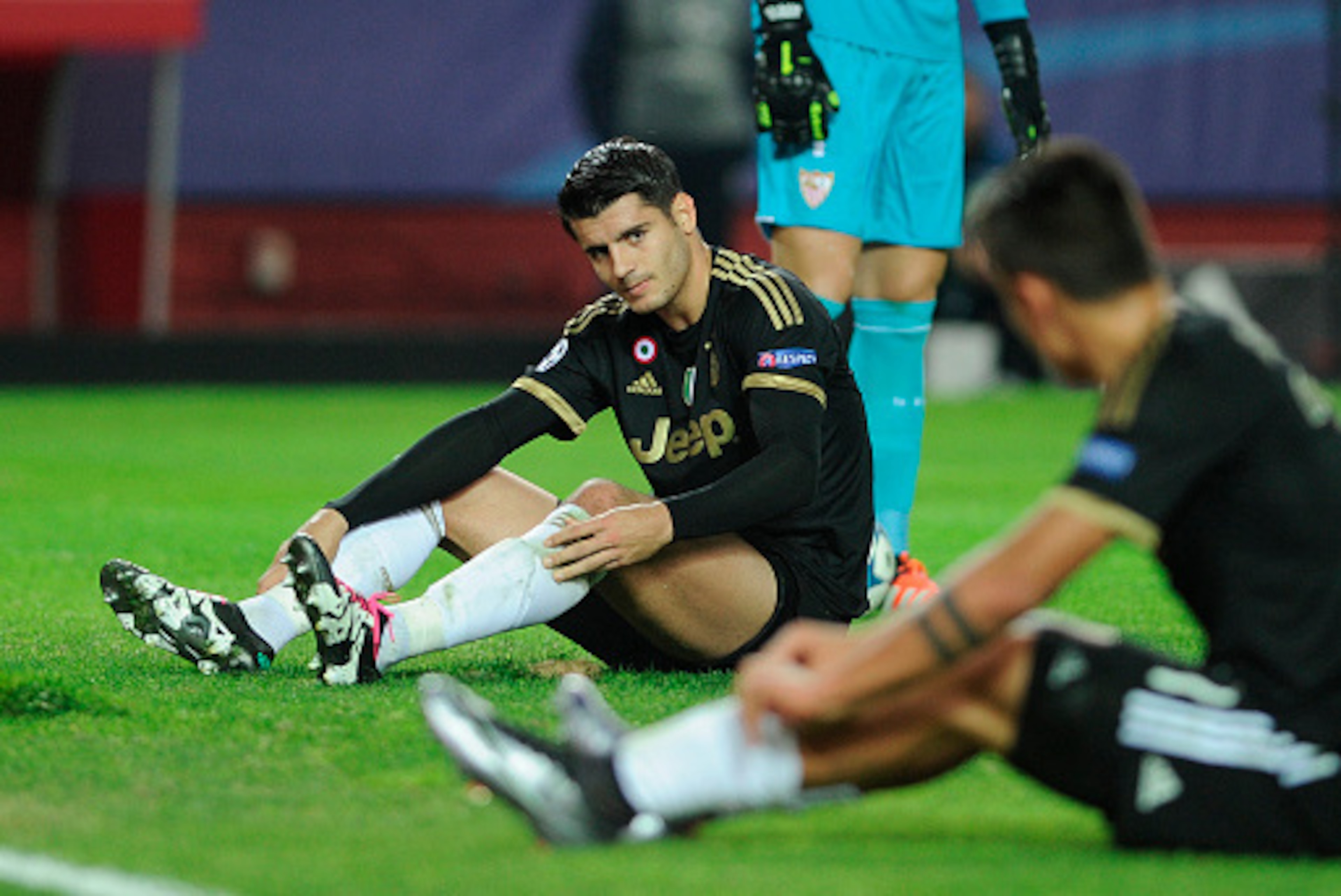 Juventus' Spanish forward Alvaro Morata (L) reacts after missing a goal opportunity during the UEFA Champions League Group D football match Sevilla FC vs Juventus at the Ramon Sanchez Pizjuan stadium in Sevilla on December 8, 2015.   AFP PHOTO/ CRISTINA Q