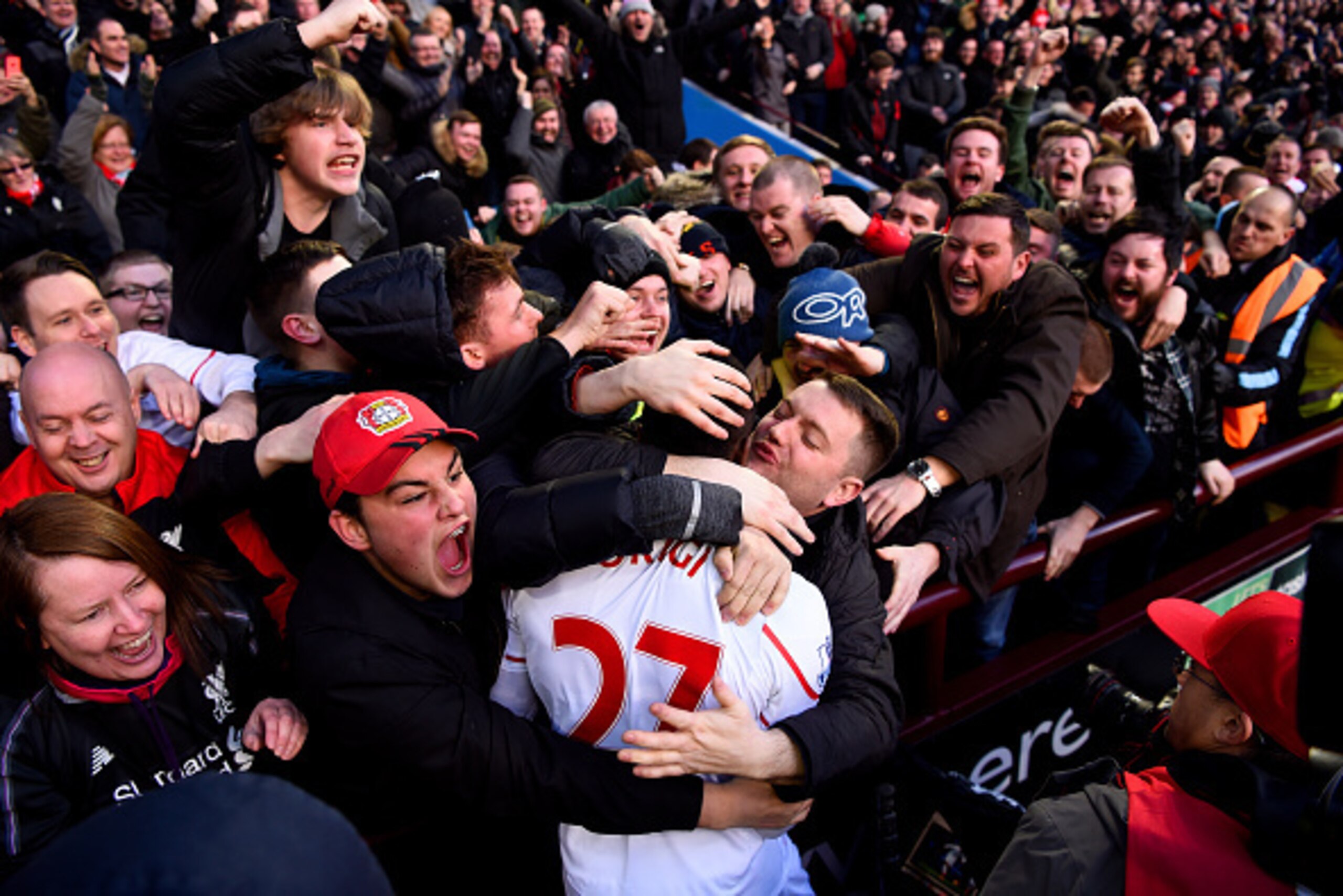 BIRMINGHAM, ENGLAND - FEBRUARY 14:  A Liverpool fan kisses Divock Origi of Liverpool as he celebrates after scoring his team's fourth goal during the Barclays Premier League match between Aston Villa and Liverpool at Villa Park on February 14, 2016 in Bir