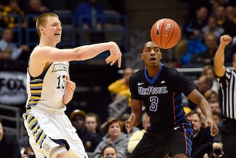 Jan 20, 2016; Milwaukee, WI, USA;   Marquette Golden Eagles forward Henry Ellenson (13) gets a pass away from DePaul Blue Demons forward Rashaun Stimage (3) in the second half at BMO Harris Bradley Center. The Blue Demons beat the Golden Eagles 57-56. Man