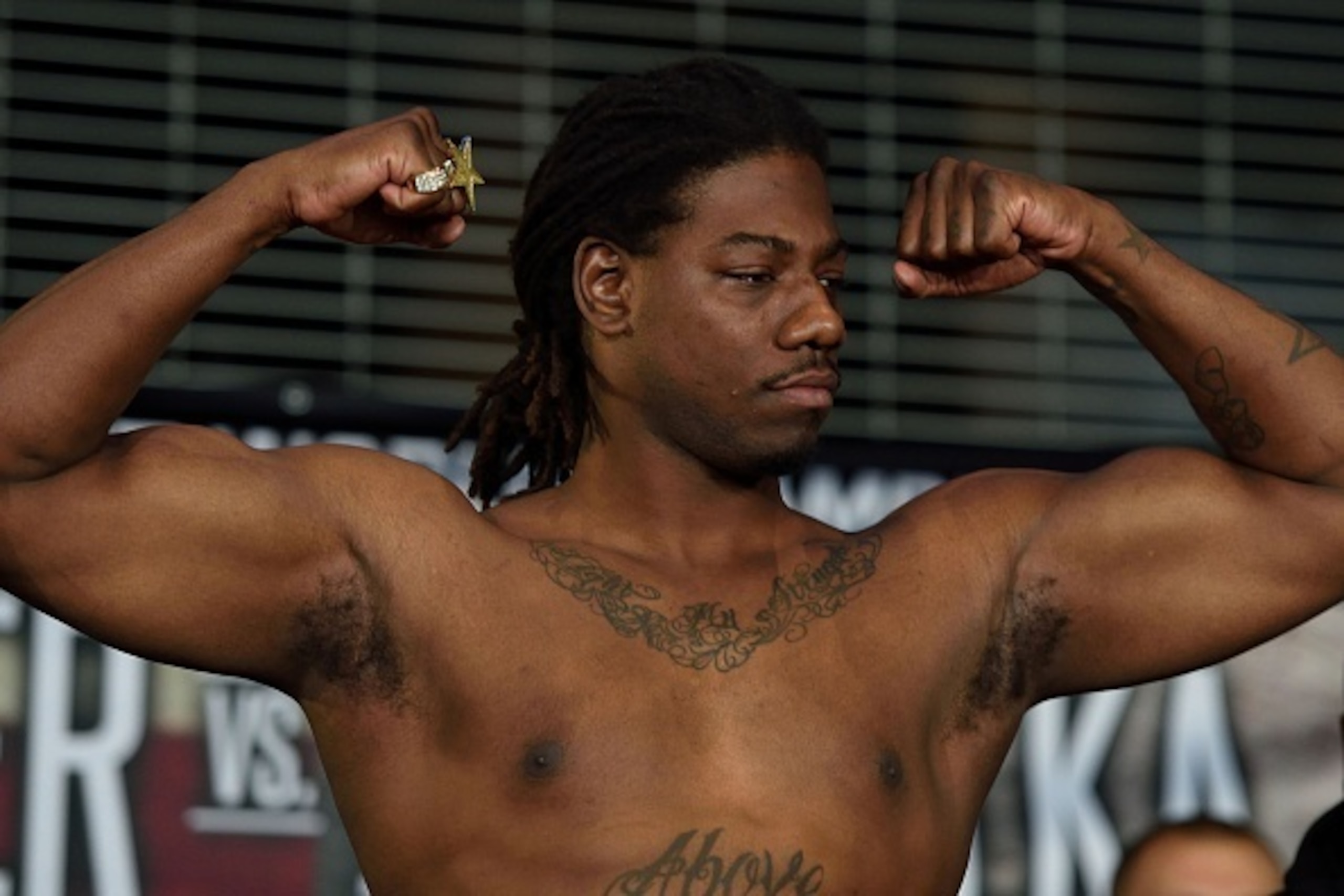 Boxer Charles Martin of the US flexes his muscles while weighing in at Barclay's Center January 15, 2016 in New York. 
Martin is scheduled to fight Vyacheslav Glazkov of the Ukraine for the IBF Heavyweight title January 16, 2016 in New York. / AFP / DON E