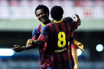 BARCELONA, SPAIN - MARCH 18:  Wilfrid Kaptoum (L) of FC Barcelona celebrates with his teammate Enguene after he scores his team's third goal during the UEFA Youth League Quarter FInal match between FC Barcelona U19 and Arsenal U19 at Mini Estadi on March 