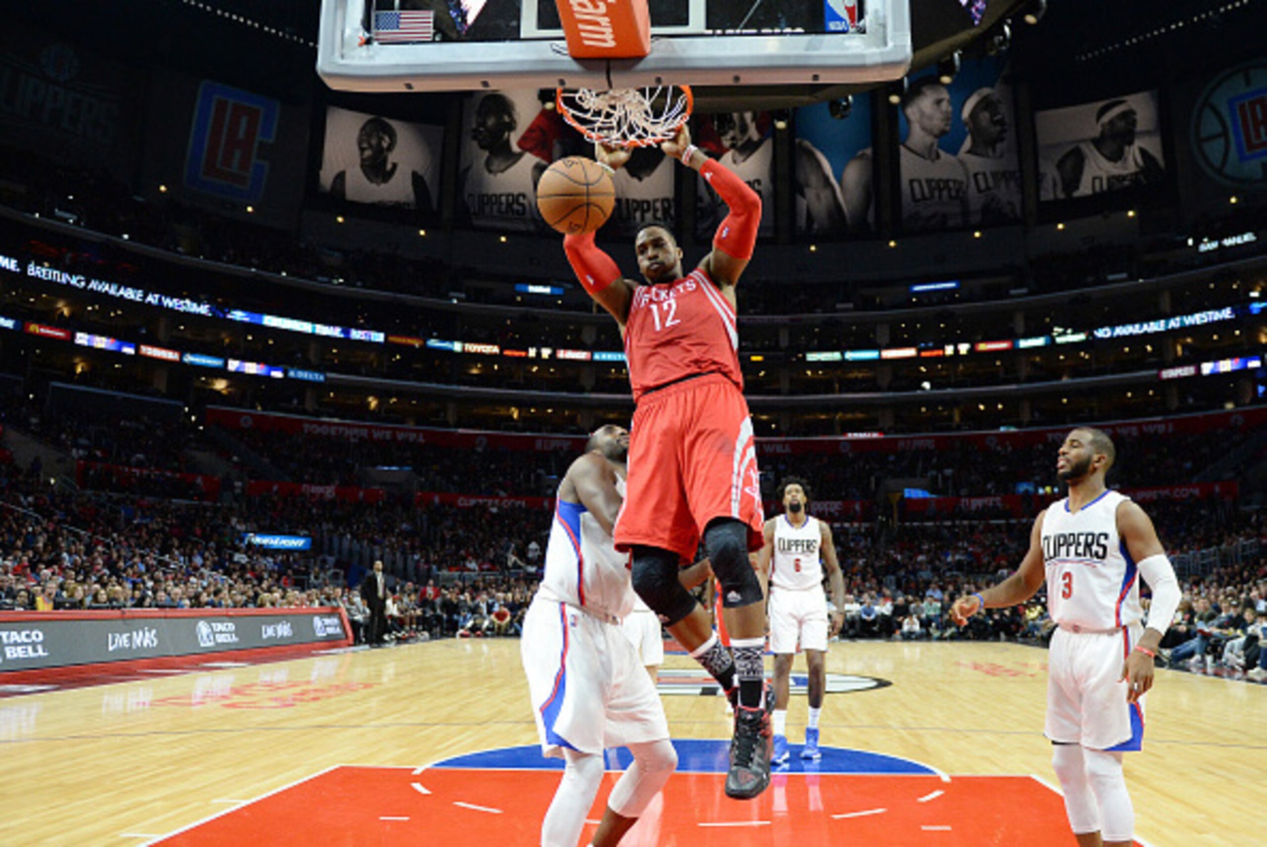 LOS ANGELES, CA - JANUARY 18: Dwight Howard #12 of the Houston Rockets slam dunks against Luc Richard Mbah a Moute #12 and Chris Paul #3 of the Los Angeles Clippers during the second half of the basketball game at Staples Center January 18, 2015, in Los A