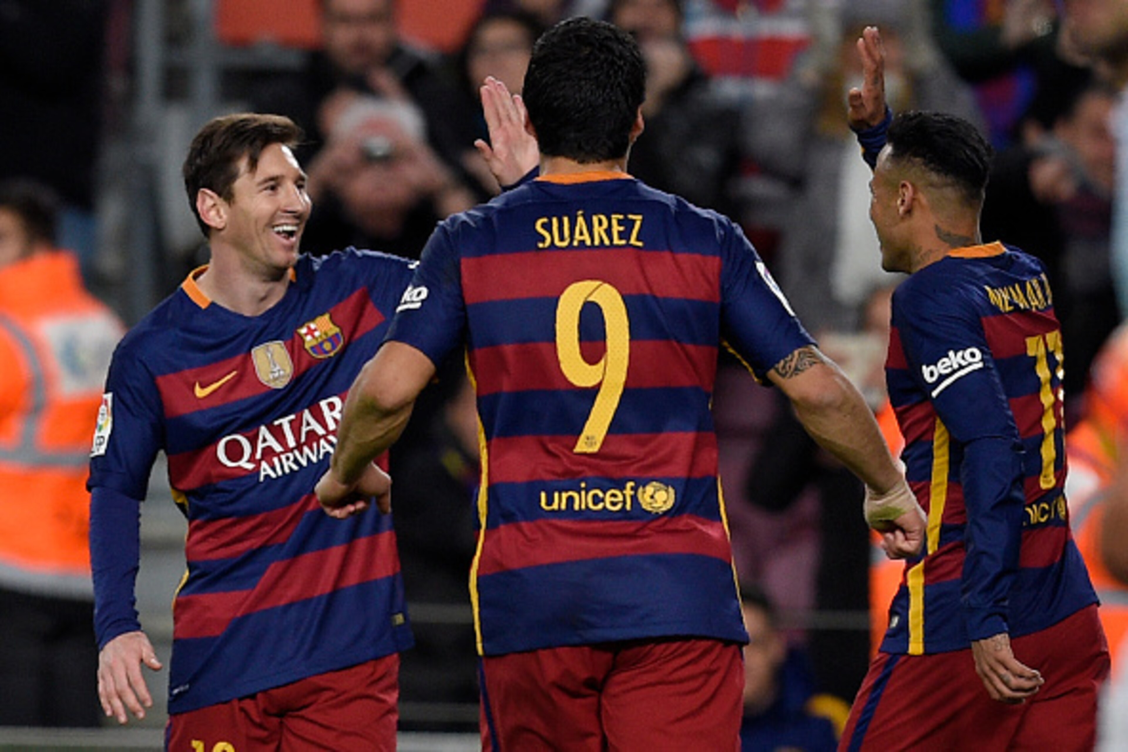 Barcelona's Uruguayan forward Luis Suarez (C) runs to celebrate a goal with Barcelona's Brazilian forward Neymar (R) and Barcelona's Argentinian forward Lionel Messi during the Spanish league football match FC Barcelona vs RC Celta de Vigo at the Camp Nou