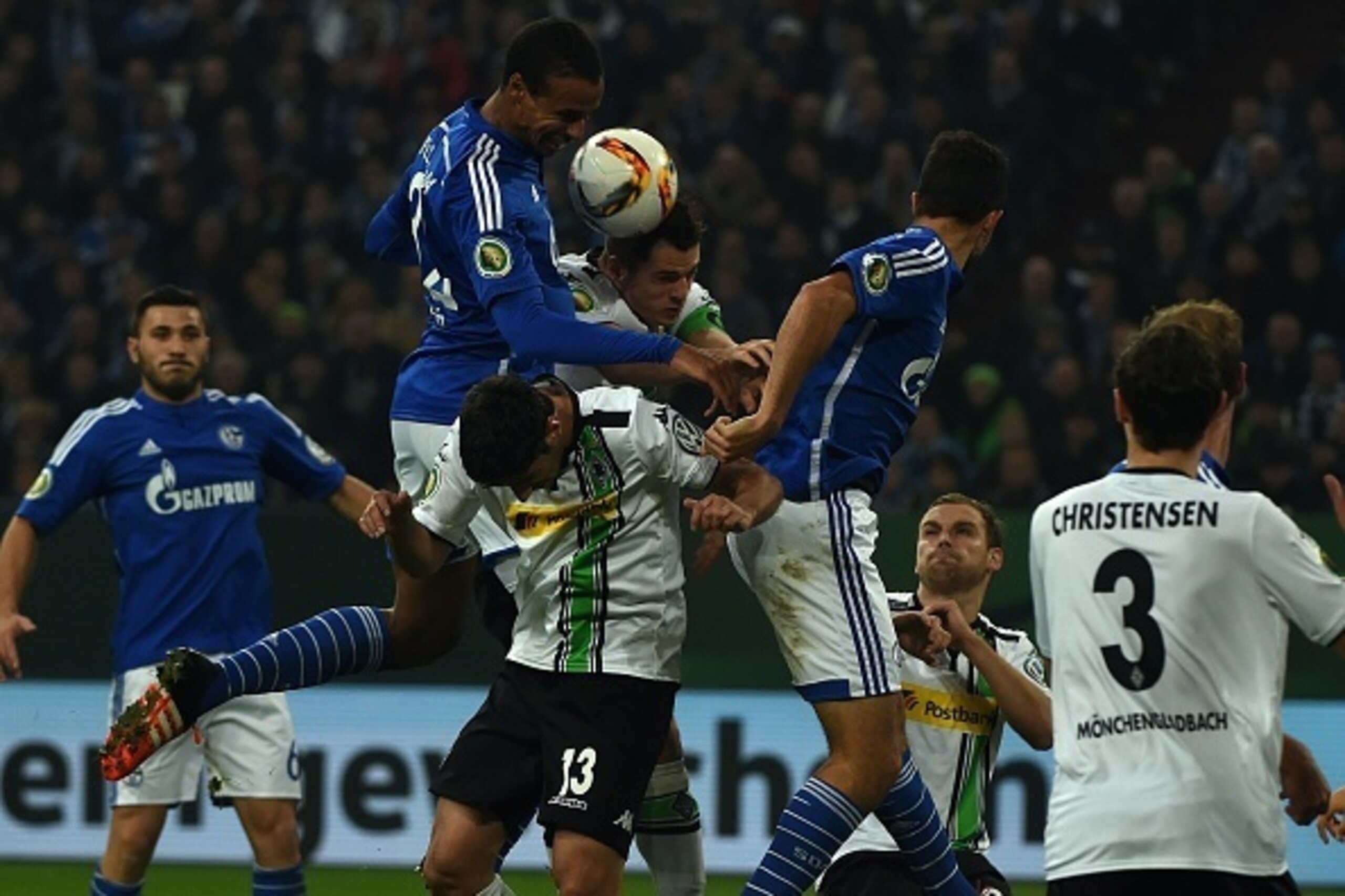 Schalke's Cameroonian defender Joel Matip , Moenchengladbach's midfielder Lars Stindl and Moenchengladbach's Swiss midfielder Granit Xhaka vie for the ball during the German Cup DFB second round football match Schalke 04 vs Borussia Moenchengladbach in Ge