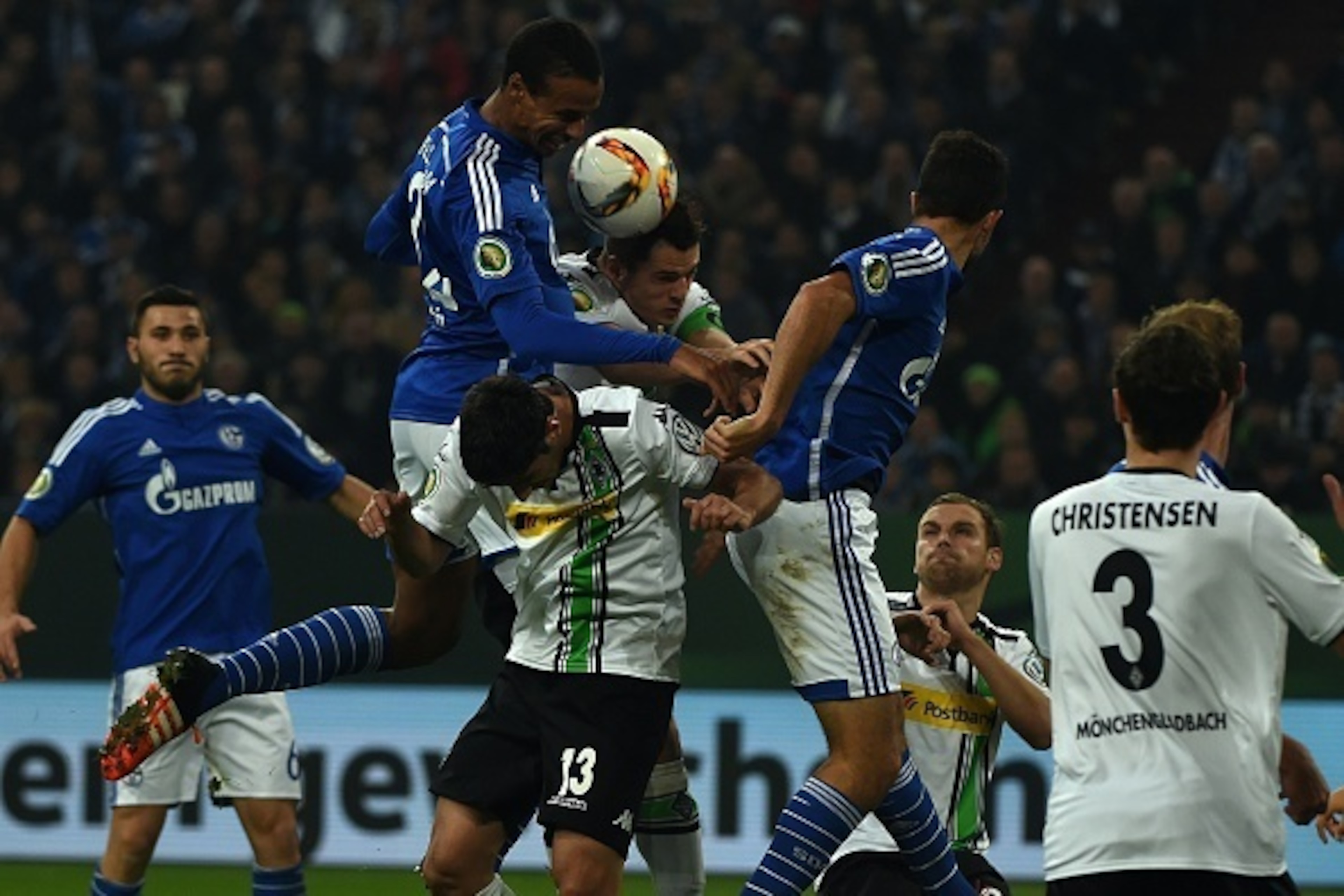 Schalke's Cameroonian defender Joel Matip , Moenchengladbach's midfielder Lars Stindl and Moenchengladbach's Swiss midfielder Granit Xhaka vie for the ball during the German Cup DFB second round football match Schalke 04 vs Borussia Moenchengladbach in Ge