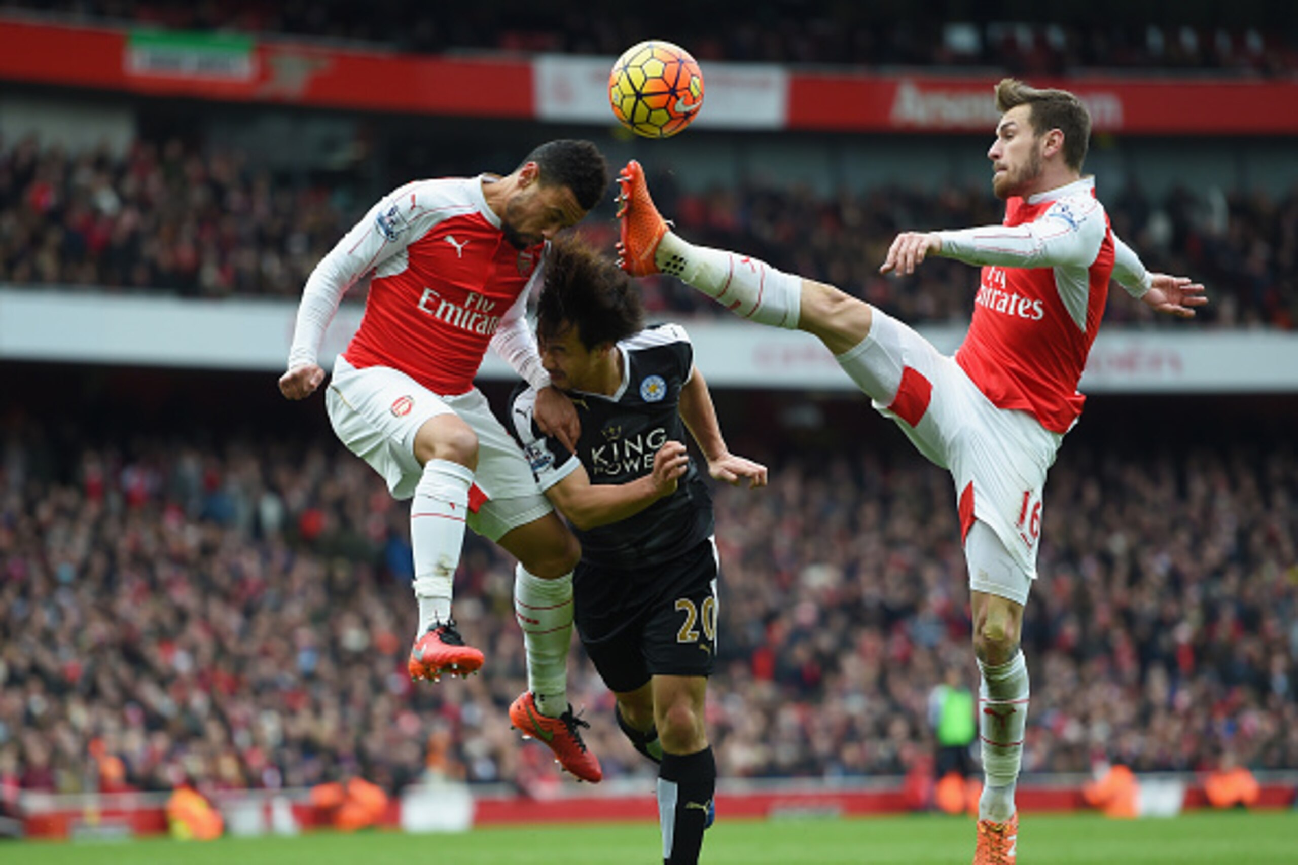 LONDON, ENGLAND - FEBRUARY 14: Francis Coquelin and Aaron Ramsey of Arsenal in action with Shinji Okazaki of Leicester City during the Barclays Premier League match between Arsenal and Leicester City at the Emirates Stadium.  (Photo by Michael Regan/Getty