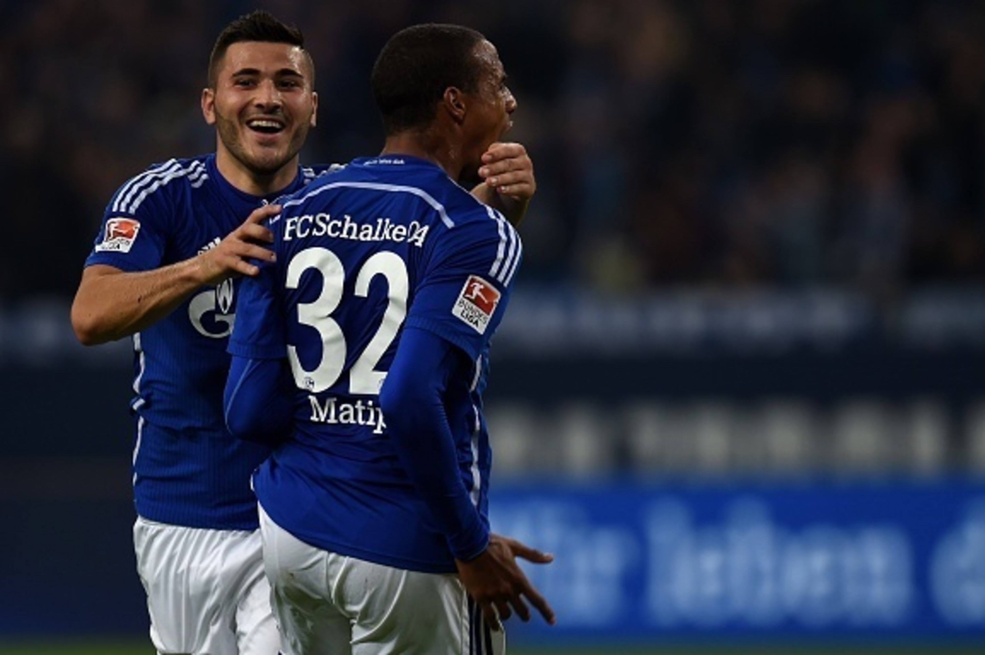 Schalke's defender Sead Kolasinac and Schalke's Cameroonian defender Joel Matip celebrate during the German first division Bundesliga football match FC Schalke 04 v Eintracht Frankfurt in Gelsenkirchen, on September 23, 2015.    AFP PHOTO / PATRIK STOLLAR