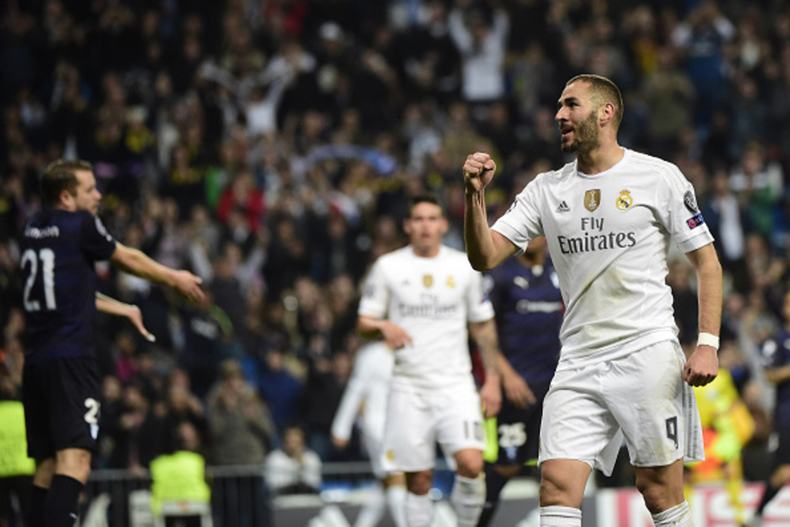 Real Madrid's French forward Karim Benzema celebrates after scoring his second goal during the UEFA Champions League Group A football match Real Madrid CF vs Malmo FF at the Santiago Bernabeu stadium in Madrid on December 8, 2015.   AFP PHOTO/ PIERRE-PHIL