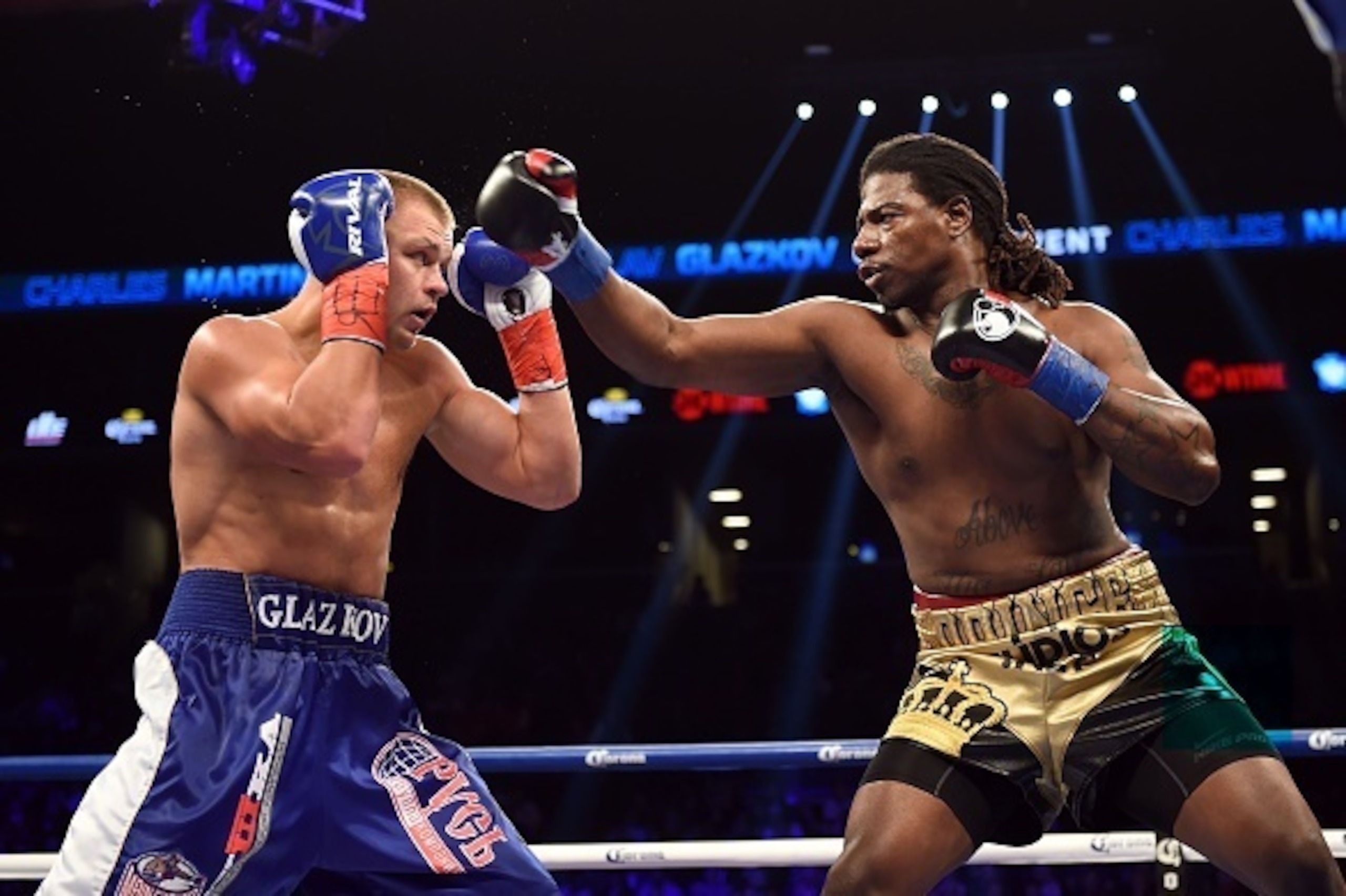 Vyacheslav Glazkov of the Ukraine (L) blocks Charles Martin of the US (R) during Round 1 of their IBF World Heavyweight Championship bout at Barclay's Center in New York's borough of Brooklyn on January 16, 2016.

 / AFP / DON EMMERT STF        (Photo cre