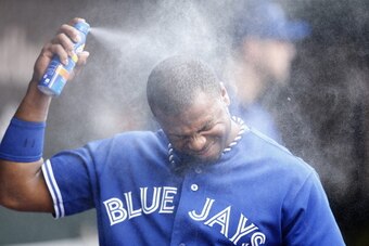 BALTIMORE, MD - JULY 13: Rajai Davis #11 of the Toronto Blue Jays sprays his face with sunscreen during the game against the Baltimore Orioles at Oriole Park at Camden Yards on July 13, 2013 in Baltimore, Maryland. The Blue Jays won 7-3. (Photo by Joe Rob