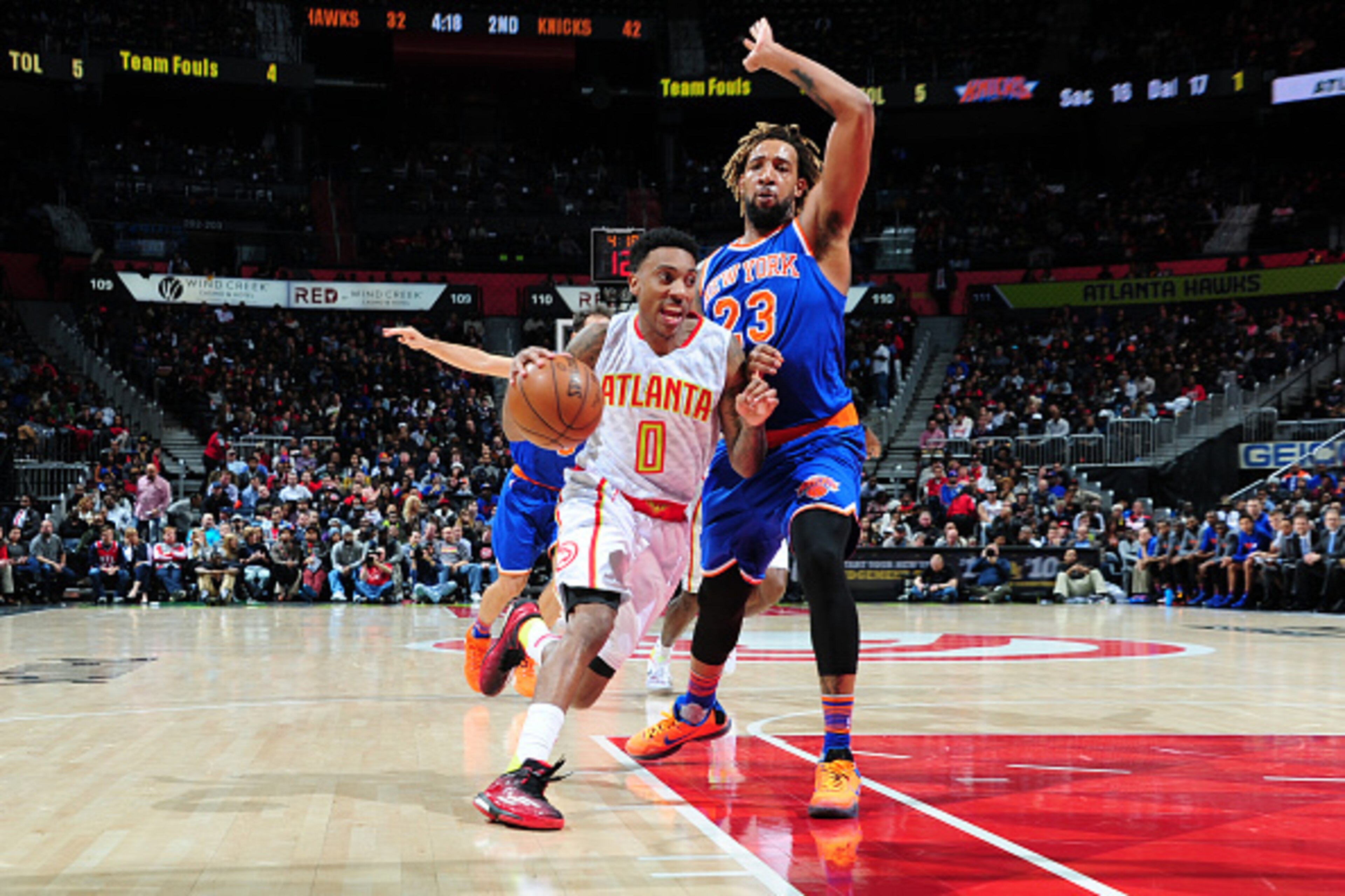 ATLANTA, GA - JANUARY 5: Jeff Teague #0 of the Atlanta Hawks drives passed Derrick Williams #23 of the New York Knicks during the game on January 5, 2016 at Philips Arena in Atlanta, Georgia. NOTE TO USER: User expressly acknowledges and agrees that, by d