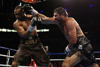 LAS VEGAS - MARCH 1:  Roy Jones Jr. is hit by a right jab from John Ruiz during their WBA heavyweight championship bout at the Thomas & Mack Center on March 1, 2003 in Las Vegas, Nevada.  Jones Jr. won the bout by way of decision after 12 rounds.  (Photo 
