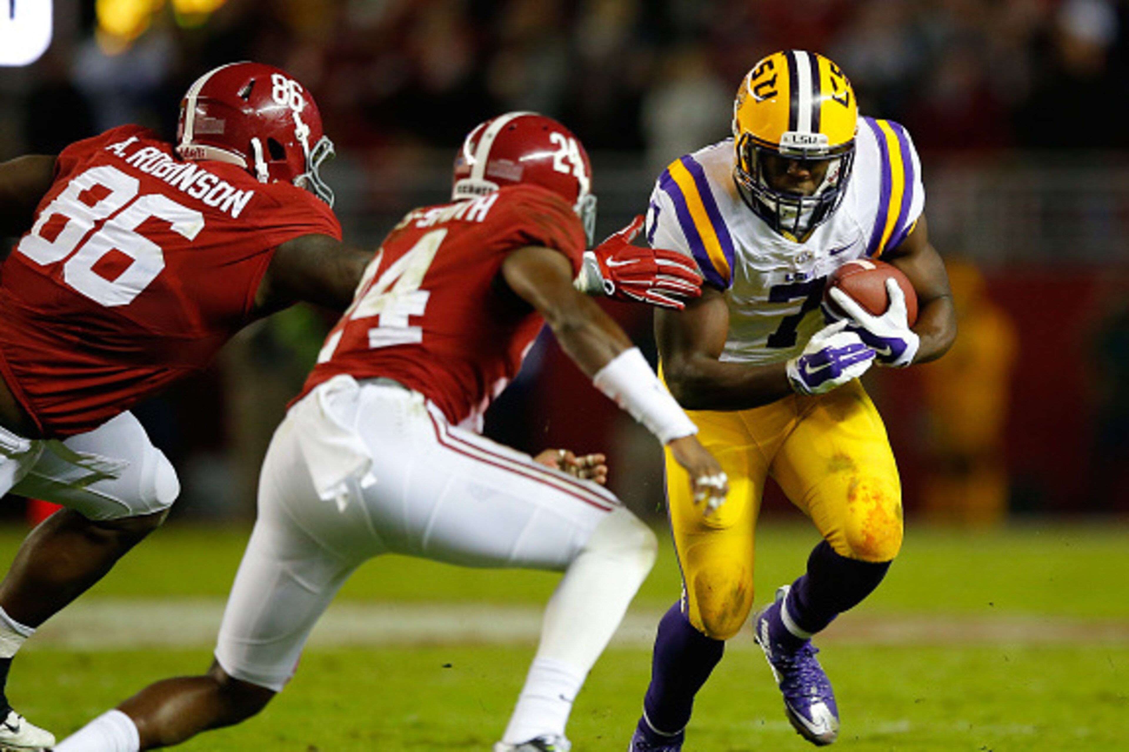 TUSCALOOSA, AL - NOVEMBER 07:  Leonard Fournette #7 of the LSU Tigers rushes against A'Shawn Robinson #86 and Geno Matias-Smith #24 of the Alabama Crimson Tide in the second quarter at Bryant-Denny Stadium on November 7, 2015 in Tuscaloosa, Alabama.  (Pho