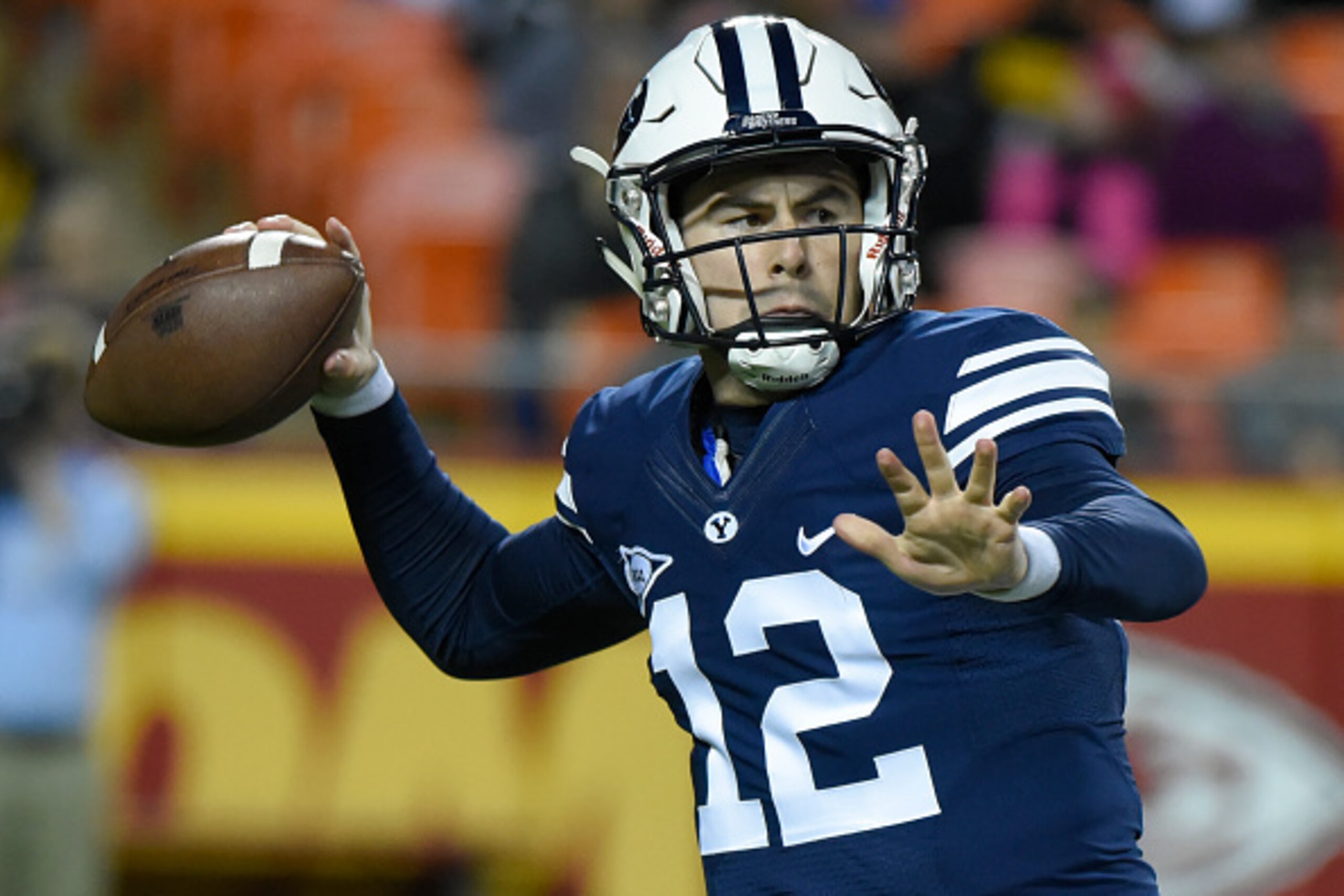 KANSAS CITY, MO - NOVEMBER 14:  Quarterback Tanner Mangum #12 of the Brigham Young Cougars passes against the Missouri Tigers in the first quarter at Arrowhead Stadium on November 14, 2015 in Kansas City, Missouri.  (Photo by Ed Zurga/Getty Images)