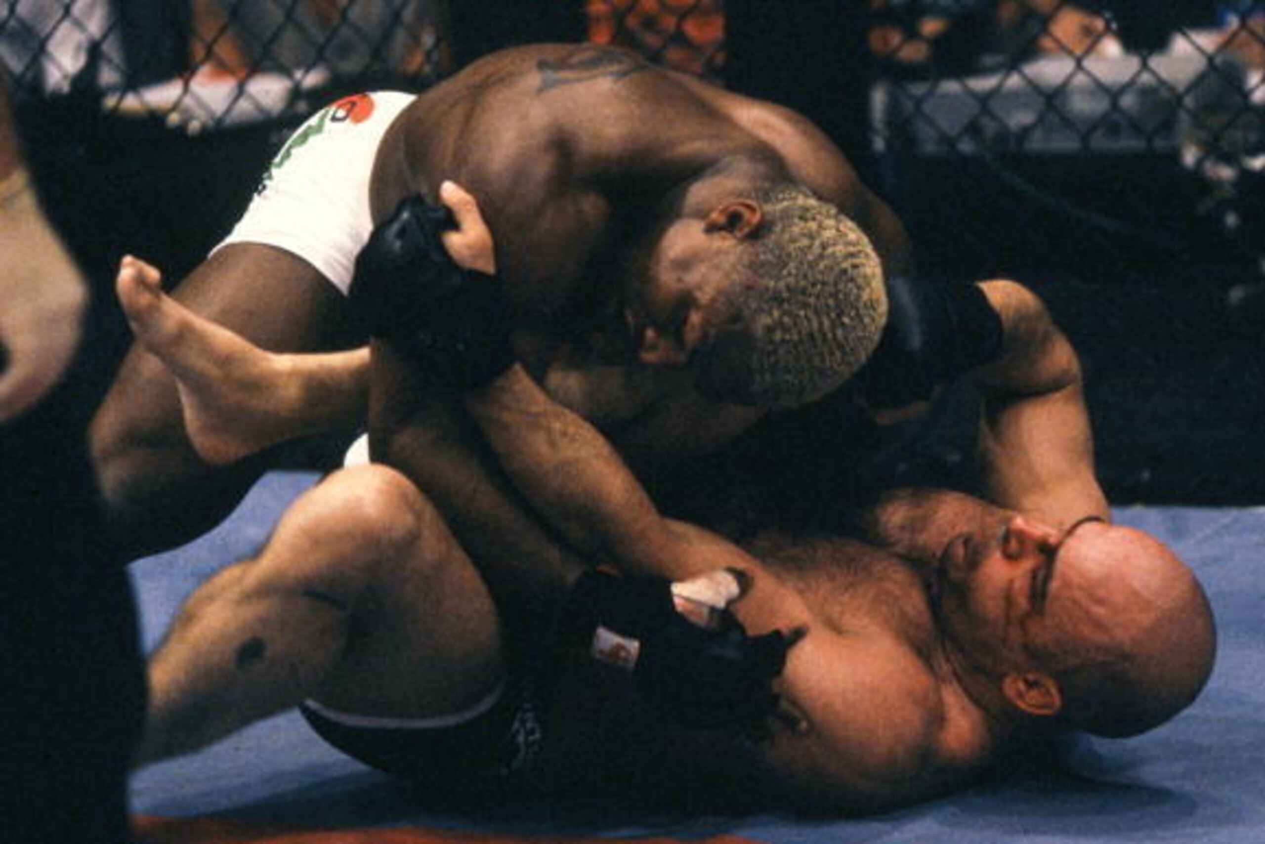 BIRMINGHAM, AL - MAY 7:  Bas Rutten (R) punches Kevin Randleman from the bottom during their UFC Heavyweight Championship bout at UFC 20 on May 7, 1999 in Birmingham, Alabama. (Photo by Zuffa LLC/Zuffa LLC via Getty Images)