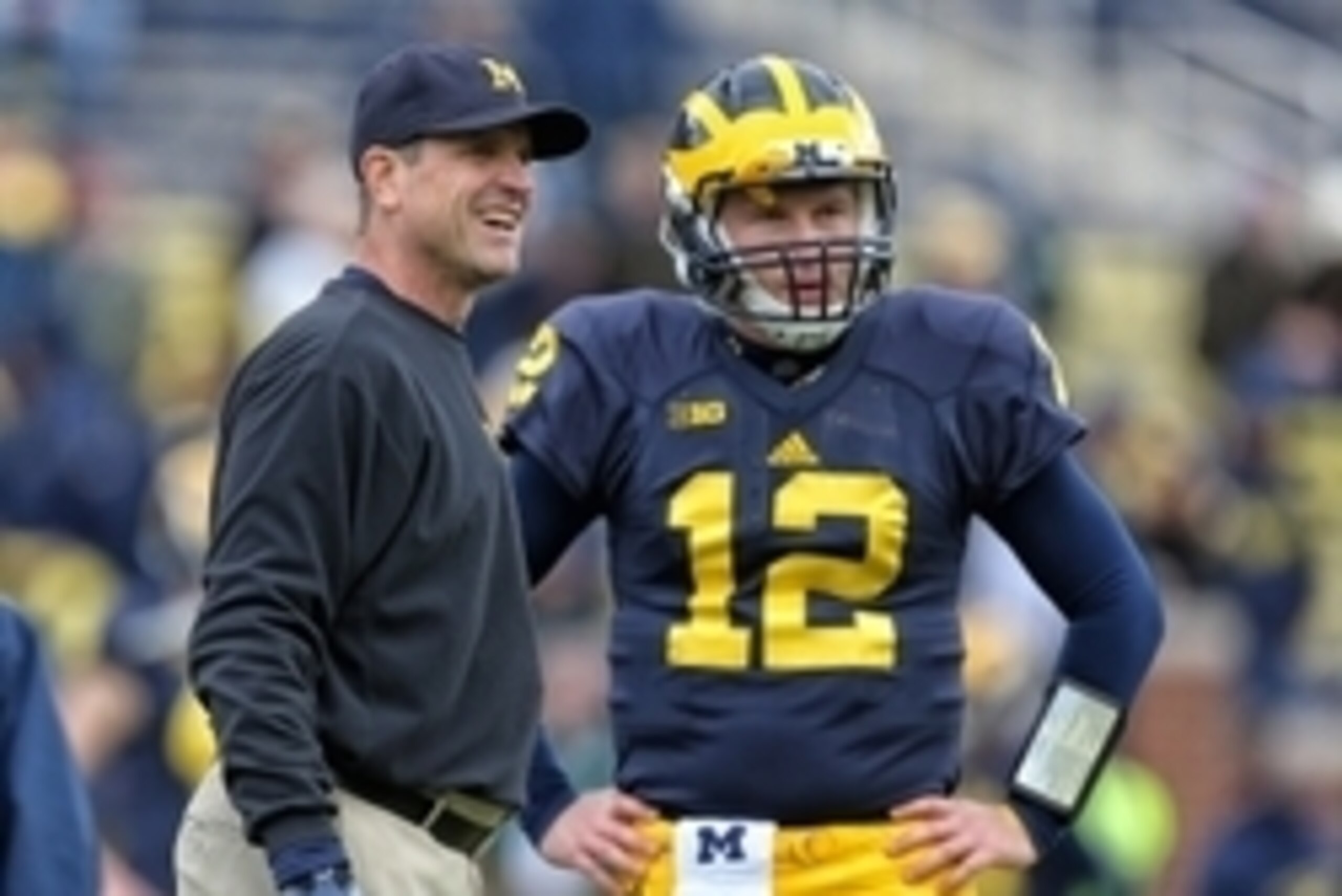 Oct 17, 2015; Ann Arbor, MI, USA; Michigan Wolverines head coach Jim Harbaugh talks to Michigan Wolverines quarterback Alex Malzone (12) prior to a game against the Michigan State Spartans at Michigan Stadium. Mandatory Credit: Mike Carter-USA TODAY Sport