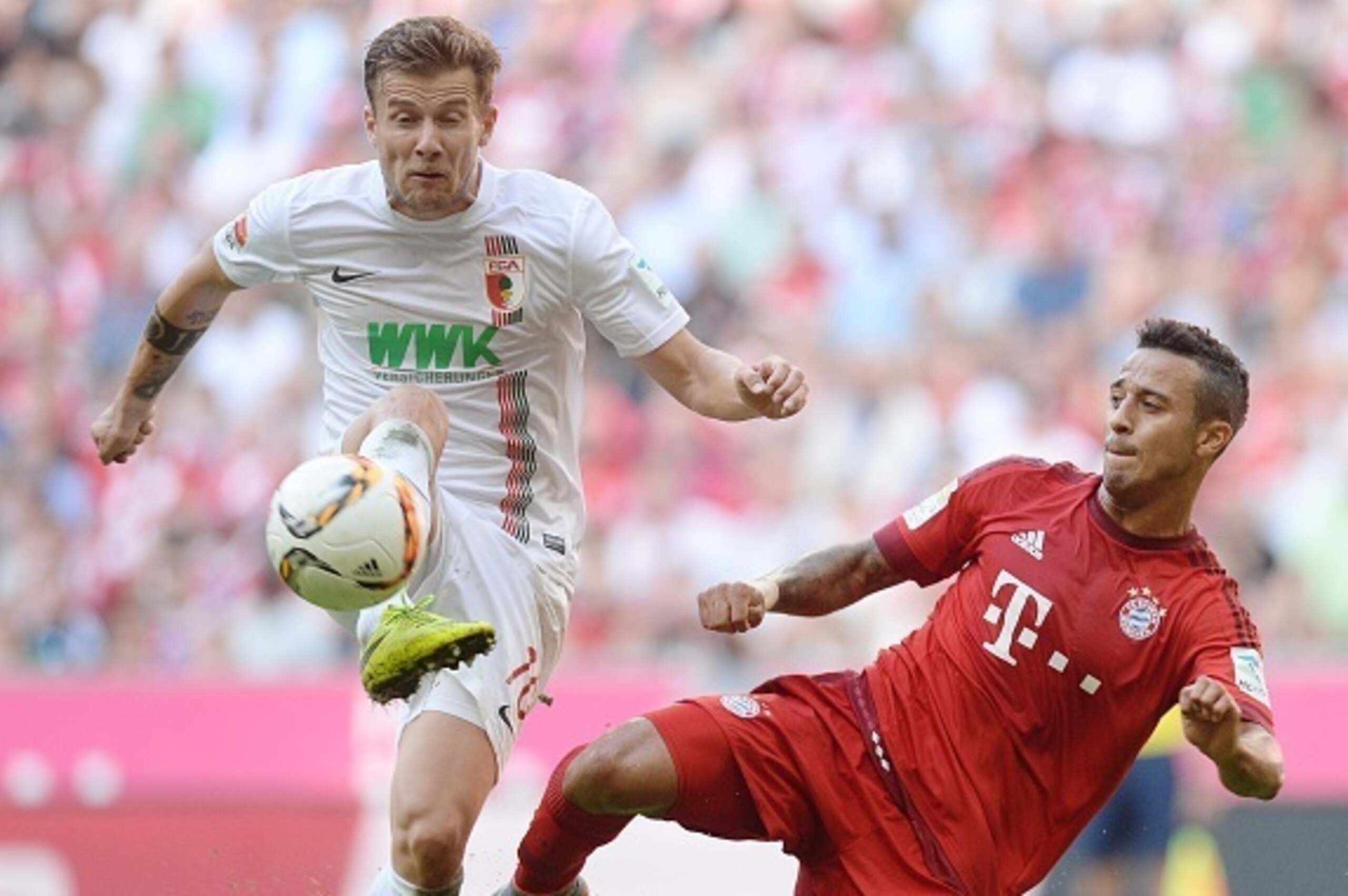 Augsburg's midfielder Daniel Baier (L) and Bayern Munich's Spanish midfielder Thiago Alcantara (R) vie for the ball during the German first division Bundesliga football match FC Bayern Munich v FC Augsburg, in Munich, on September 12, 2015. AFP PHOTO /CH Augsburg's midfielder Daniel Baier (L) and Bayern Munich's Spanish midfielder Thiago Alcantara (R) vie for the ball during the German first division Bundesliga football match FC Bayern Munich v FC Augsburg, in Munich, on September 12, 2015. AFP PHOTO /CH