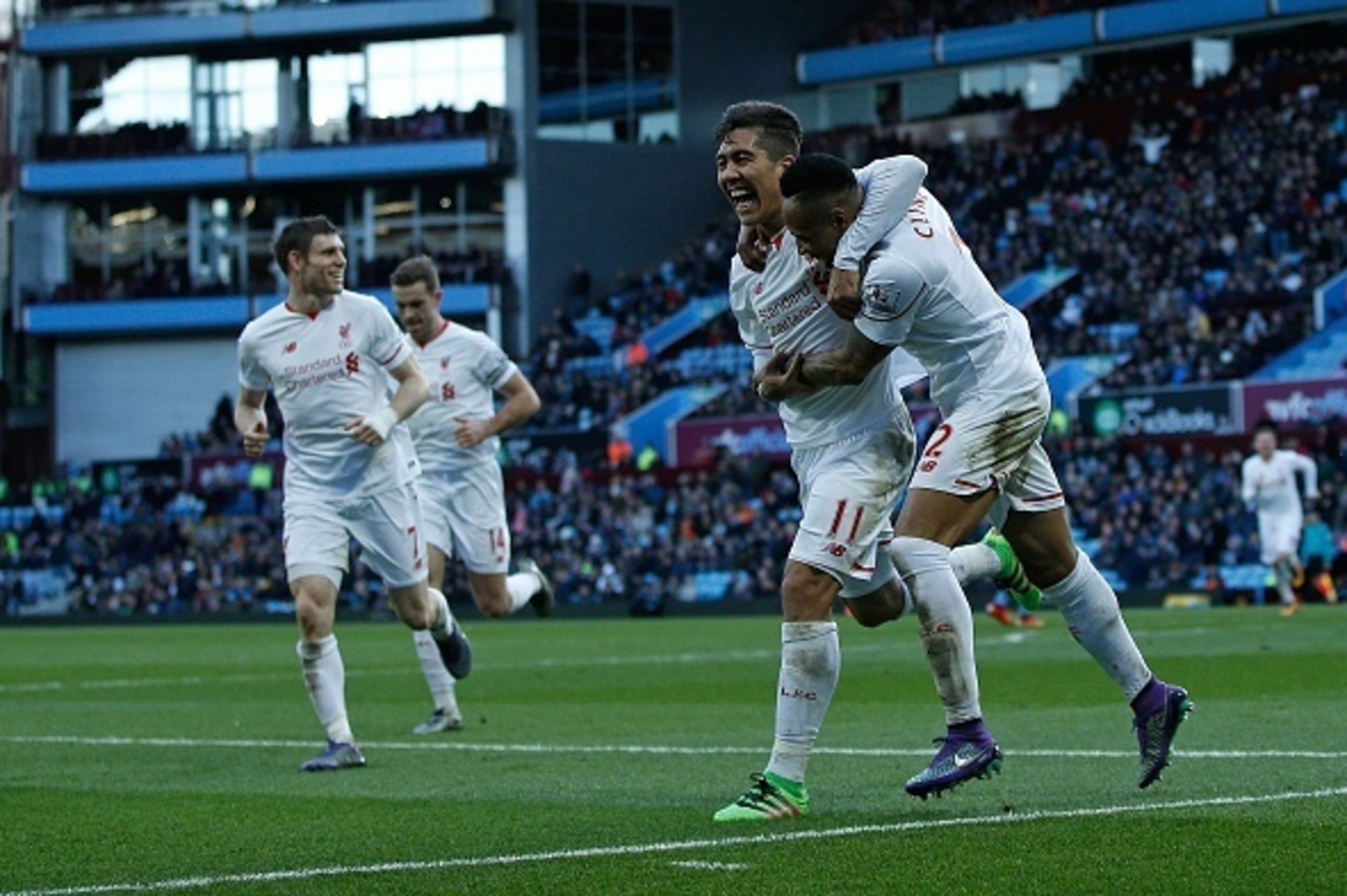 Liverpool's English defender Nathaniel Clyne (R) celebrates scoring his team's fifth goal with Liverpool's Brazilian midfielder Roberto Firmino (2R) and Liverpool's English midfielder James Milner (L) during the English Premier League football match betwe