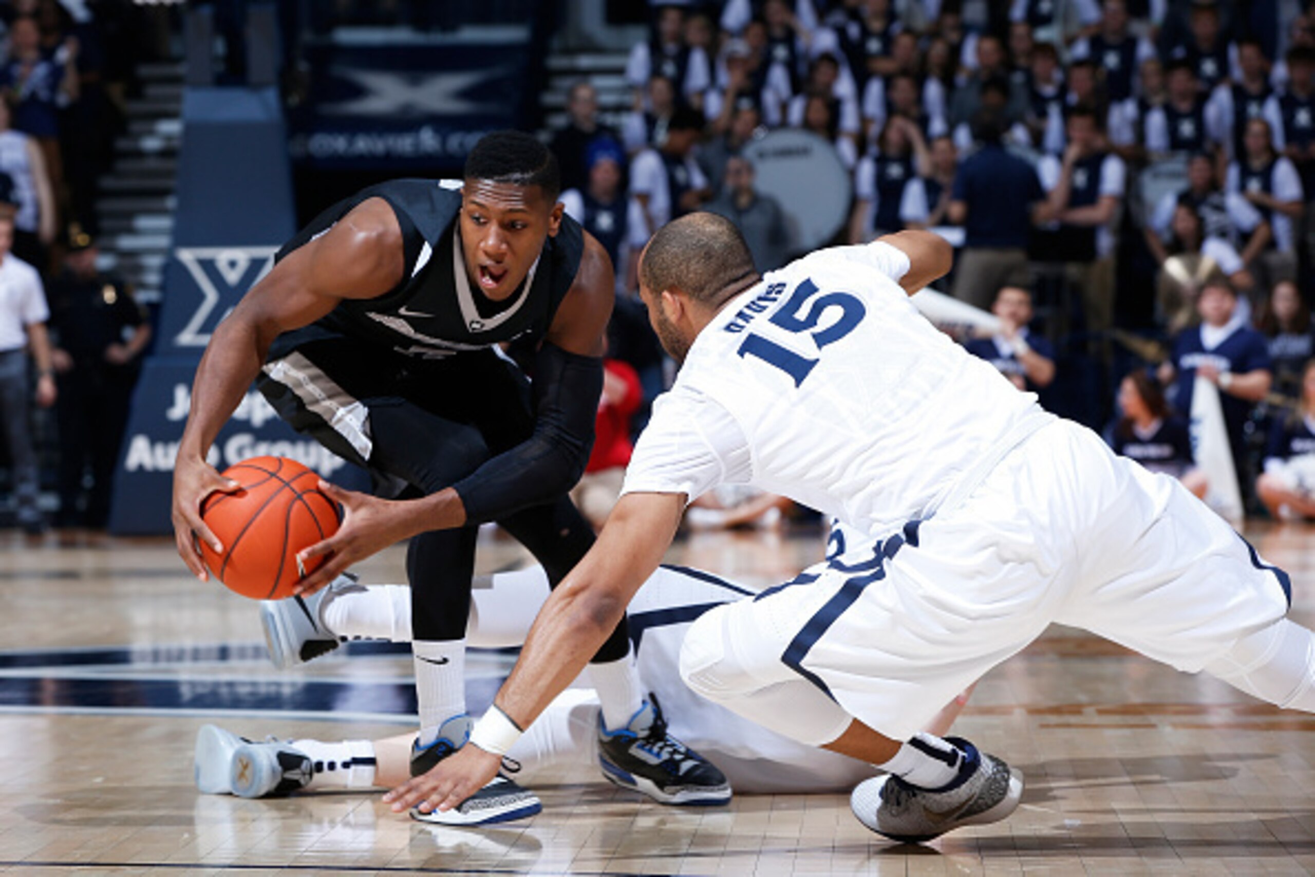CINCINNATI, OH - FEBRUARY 17: Kris Dunn #3 of the Providence Friars gets a loose ball ahead of Myles Davis #15 of the Xavier Musketeers in the first half of the game at Cintas Center on February 17, 2016 in Cincinnati, Ohio. (Photo by Joe Robbins/Getty Im