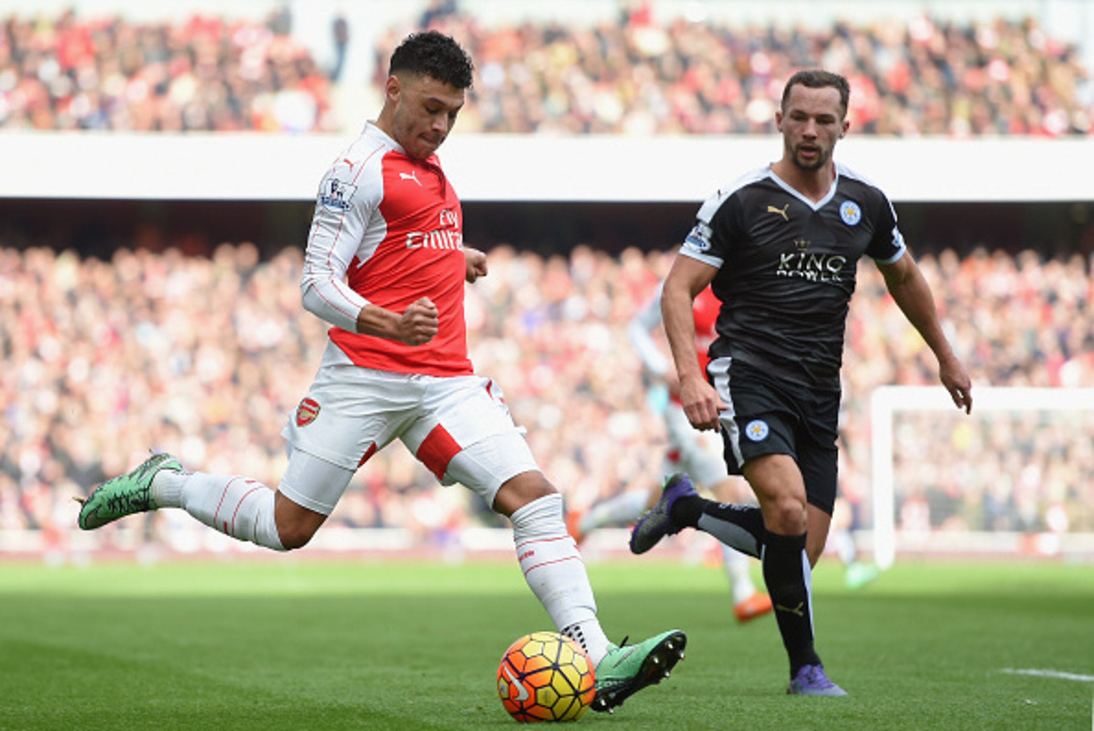 LONDON, ENGLAND - FEBRUARY 14:  Alex Oxlade-Chamberlain of Arsenal takes on Danny Drinkwater of Leicester City during the Barclays Premier League match between Arsenal and Leicester City at the Emirates Stadium.  (Photo by Michael Regan/Getty Images)