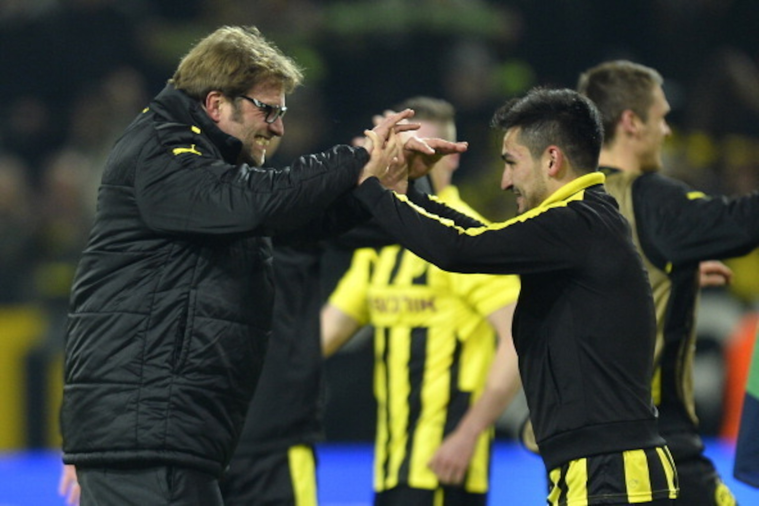 Dortmund's head coach Juergen Klopp (L) celebrates with Dortmund's midfielder Ilkay Guendogan after the UEFA Champions League quarter-final second-leg football match Borussia Dortmund vs Malaga CF in Dortmund, western Germany on April 9, 2013. Dortmund wo