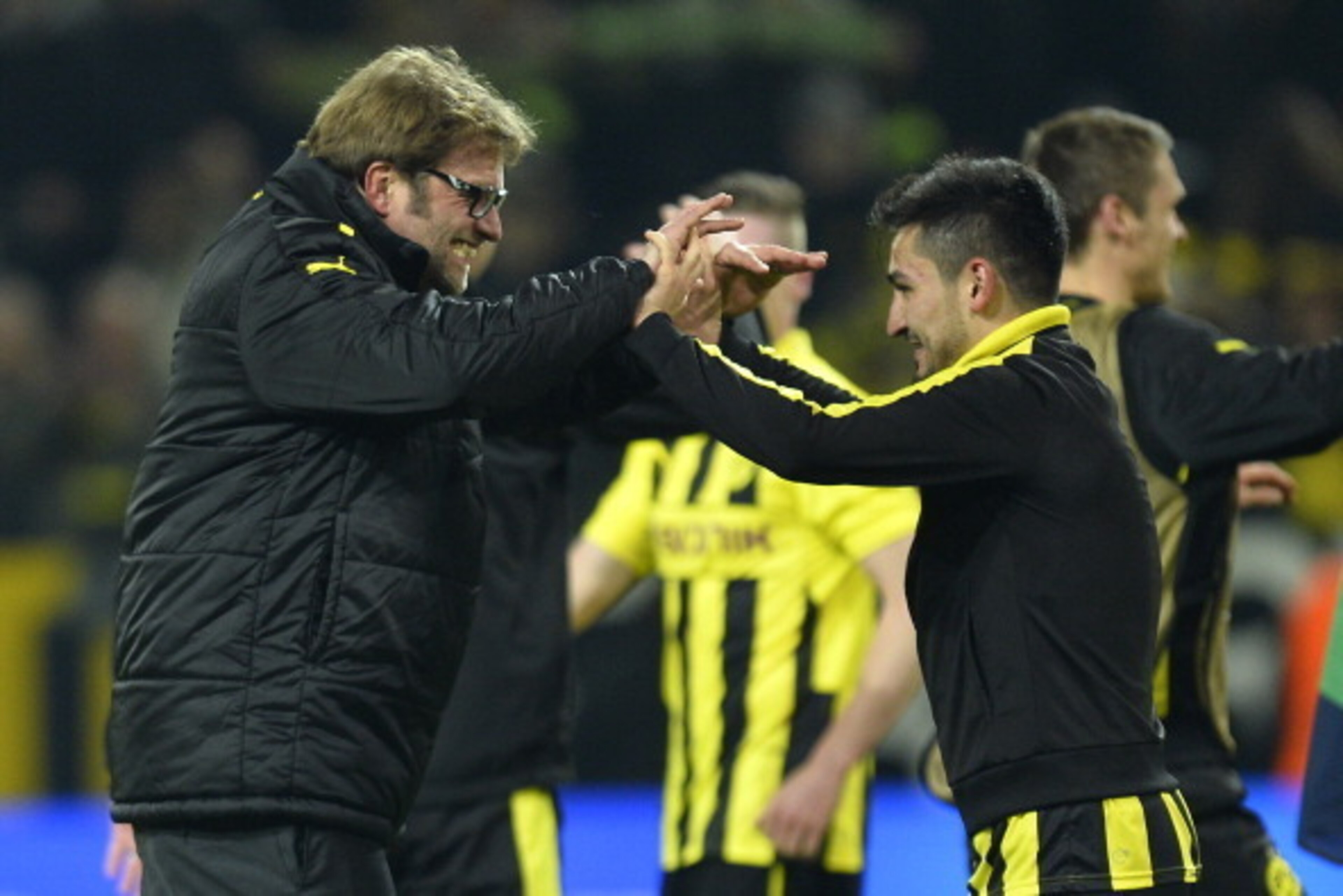 Dortmund's head coach Juergen Klopp (L) celebrates with Dortmund's midfielder Ilkay Guendogan after the UEFA Champions League quarter-final second-leg football match Borussia Dortmund vs Malaga CF in Dortmund, western Germany on April 9, 2013. Dortmund wo Dortmund's head coach Juergen Klopp (L) celebrates with Dortmund's midfielder Ilkay Guendogan after the UEFA Champions League quarter-final second-leg football match Borussia Dortmund vs Malaga CF in Dortmund, western Germany on April 9, 2013. Dortmund wo