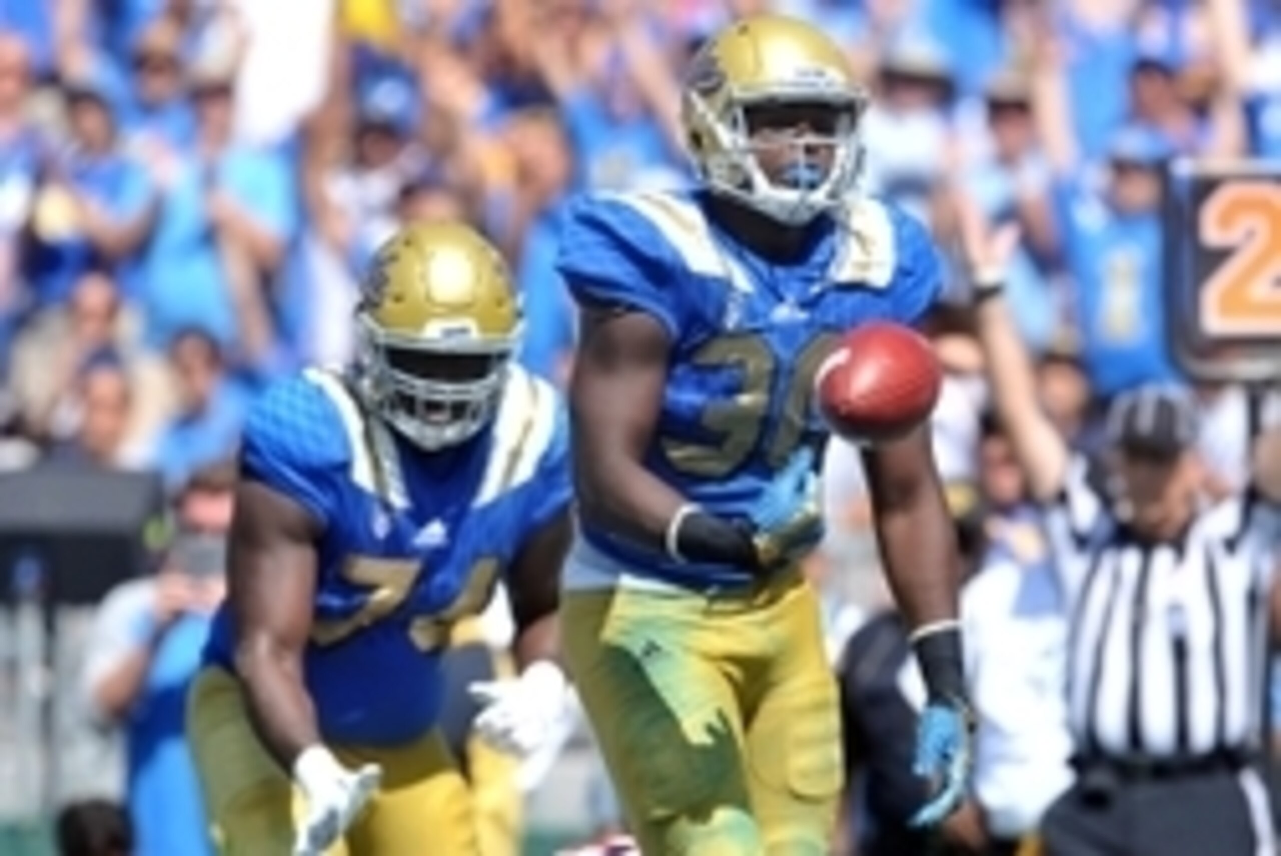 September 5, 2015; Pasadena, CA, USA; UCLA Bruins linebacker Myles Jack (30) celebrates after running in the ball for a touchdown on offense against the Virginia Cavaliers during the second half at the Rose Bowl. Mandatory Credit: Gary A. Vasquez-USA TODA