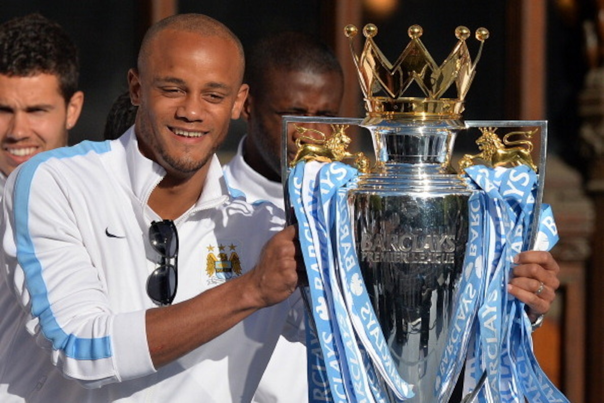 Manchester City's Belgian defender Vincent Kompany holds the Premiership trophy as Manchester City football club players prepare to take part in a victory parade on an open-topped bus through the streets of Manchester, northwest England, on May 12, 2014, 