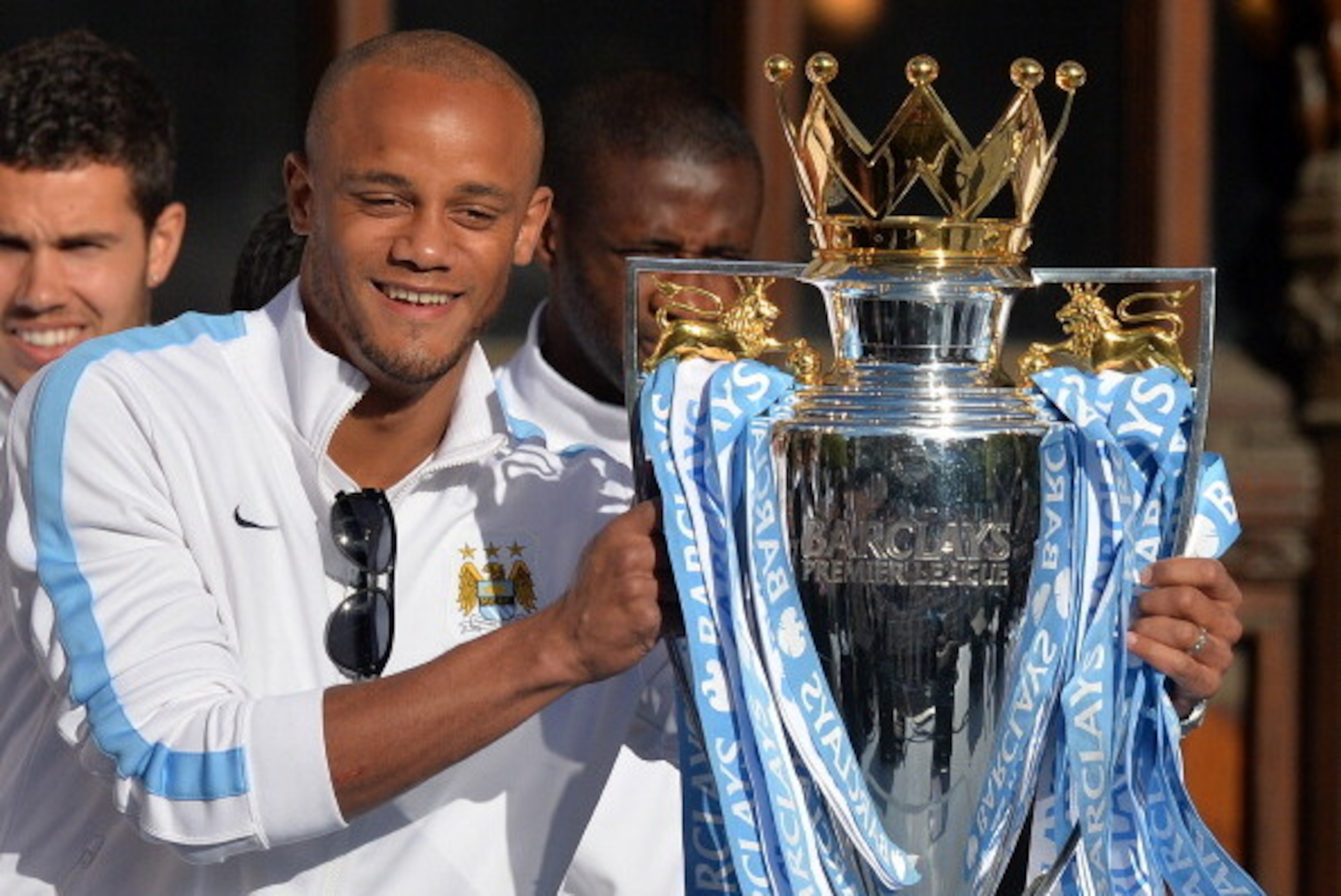 Manchester City's Belgian defender Vincent Kompany holds the Premiership trophy as Manchester City football club players prepare to take part in a victory parade on an open-topped bus through the streets of Manchester, northwest England, on May 12, 2014, 