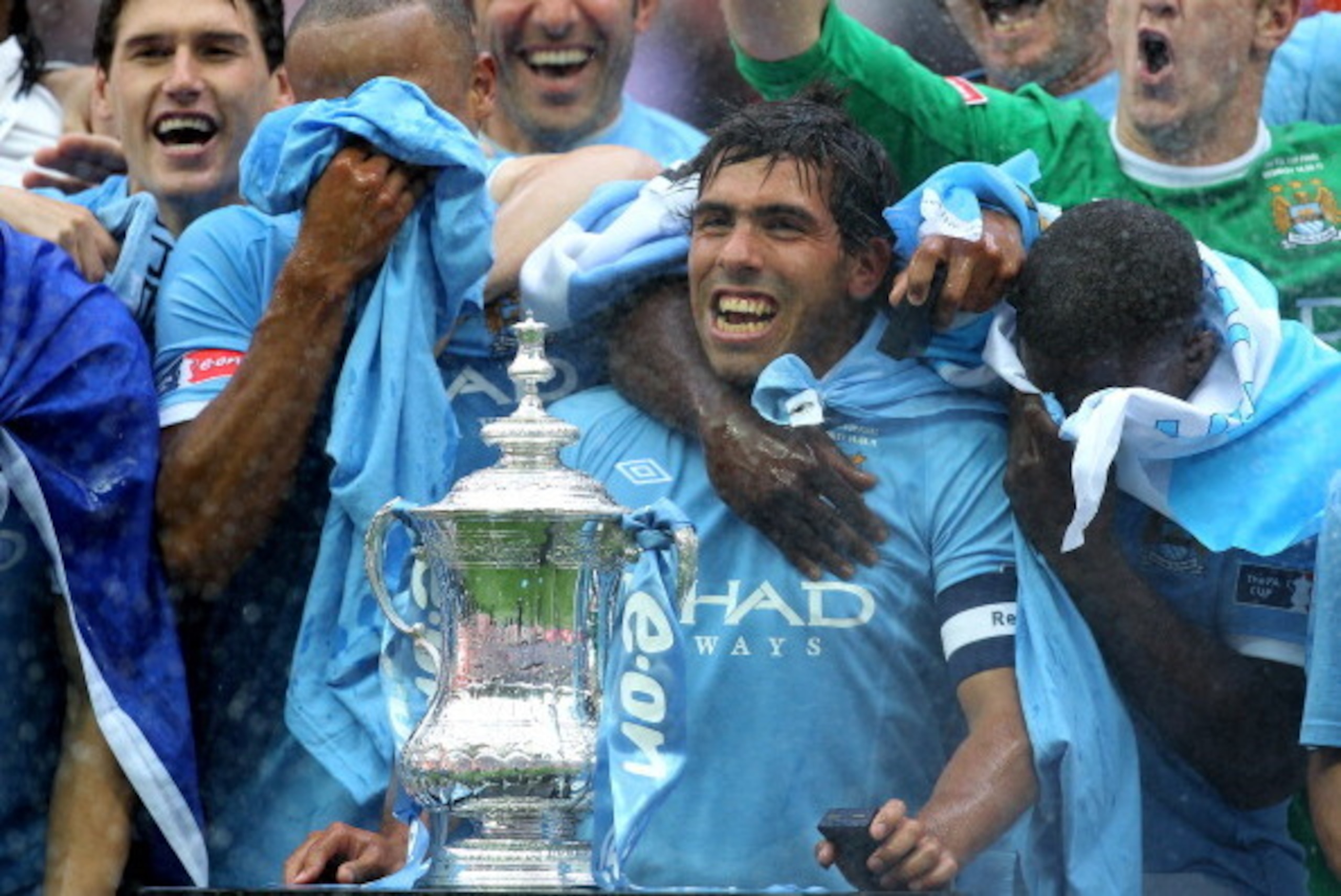 LONDON, ENGLAND - MAY 14:  Carlos Tevez of Manchester City and his team mates celebrate with the trophy after they won the FA Cup sponsored by E.ON Final match between Manchester City and Stoke City at Wembley Stadium on May 14, 2011 in London, England.  