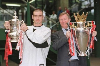 12th May 1996; Manchester United manager Alex Ferguson and Eric Cantona with the FA Cup and Premiership trophy on their arrival at Manchester's Victoria station. Mandatory Credit: Shaun Botterill/ALLSPORT