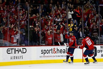 WASHINGTON, DC - FEBRUARY 16: Nate Schmidt #88 looks on as teammate Evgeny Kuznetsov #92 of the Washington Capitals celebrates after scoring a third period goal against the Los Angeles Kings during their 3-1 win at Verizon Center on February 16, 2016 in W