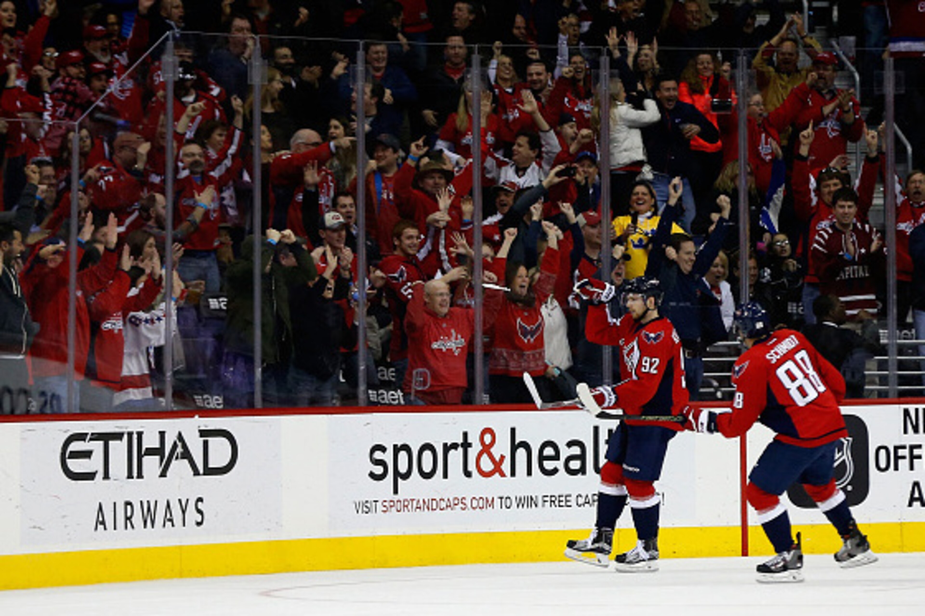 WASHINGTON, DC - FEBRUARY 16: Nate Schmidt #88 looks on as teammate Evgeny Kuznetsov #92 of the Washington Capitals celebrates after scoring a third period goal against the Los Angeles Kings during their 3-1 win at Verizon Center on February 16, 2016 in W