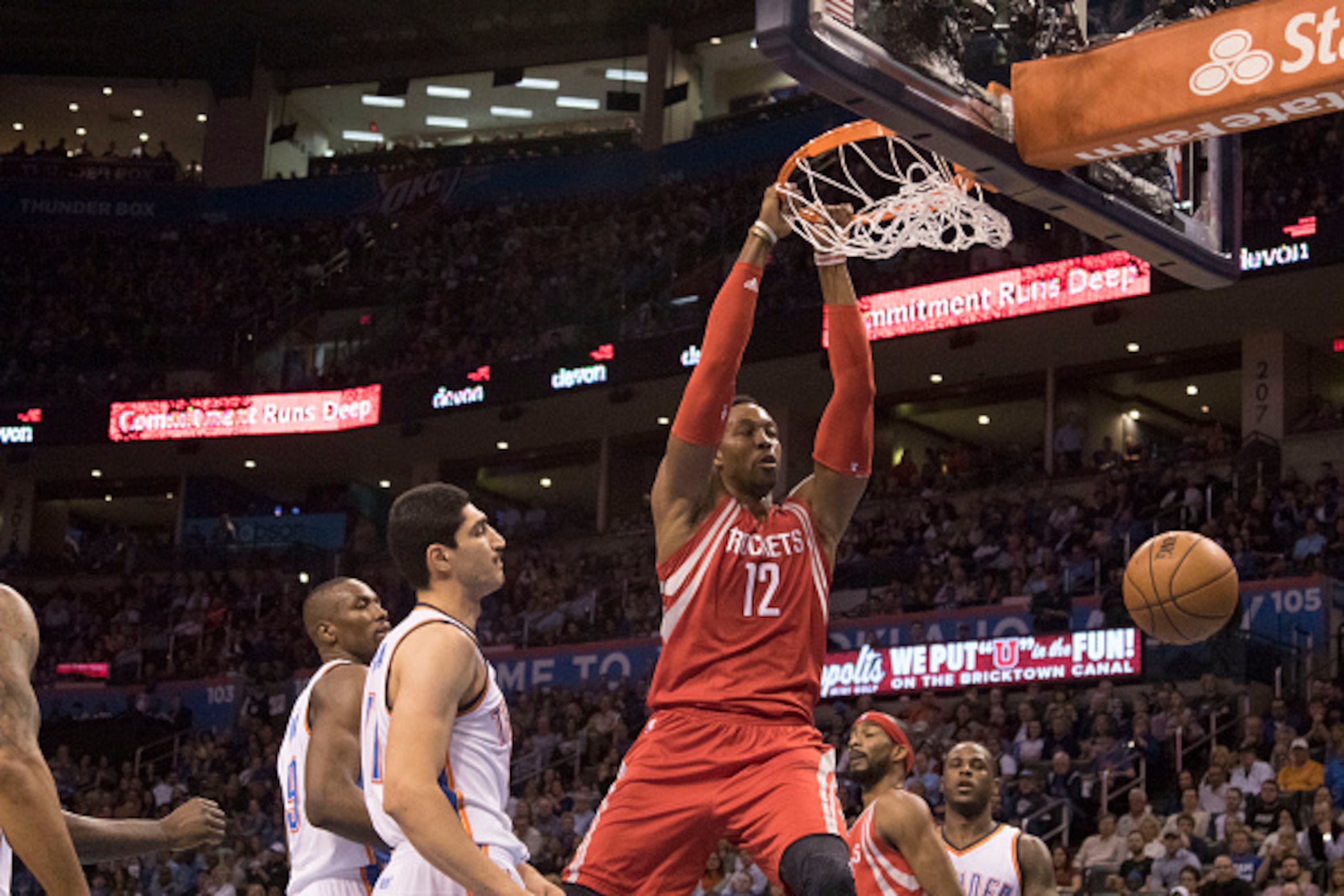 OKLAHOMA CITY, OK - JANUARY 29: As Oklahoma City Thunder players watch Dwight Howard #12 of the Houston Rockets dunks two points during a NBA game at the Chesapeake Energy Arena on January 29, 2016 in Oklahoma City, Oklahoma. NOTE TO USER: User expressly 