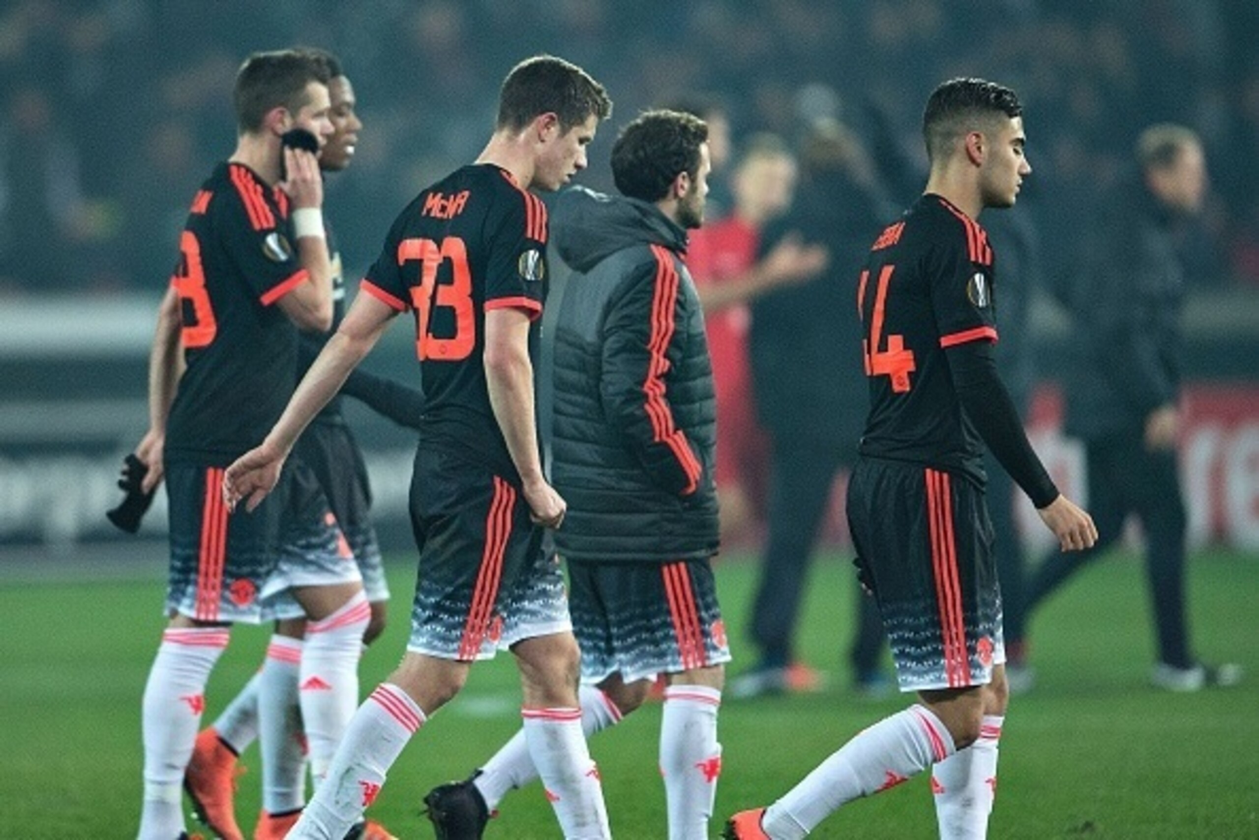 Manchester United's Northern Irish midfielder Paddy McNair (C) and teammates reacts after the the UEFA Europa League Round of 32 football match between Manchester United and FC Midtjylland in Hernin on February 18, 2016. / AFP / Scanpix Denmark / Henning 