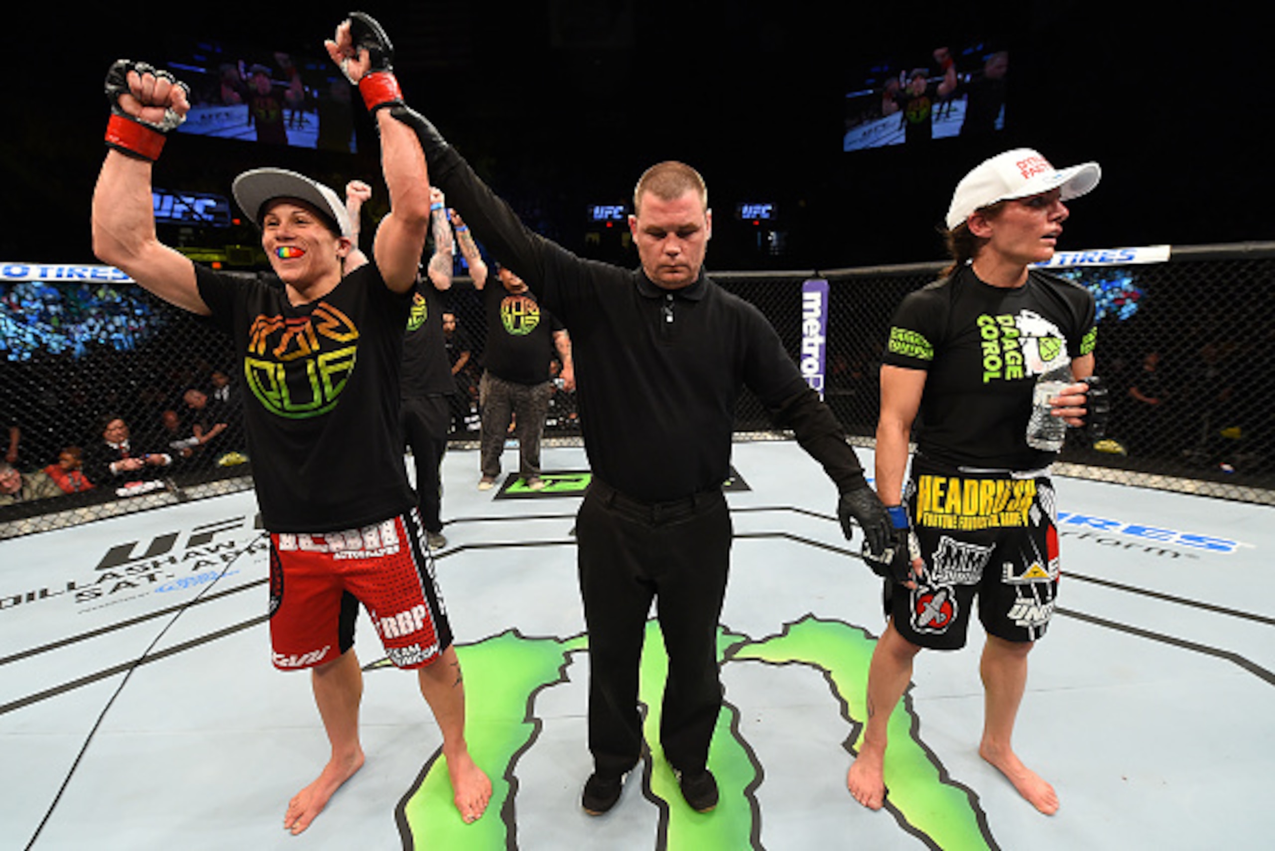 FAIRFAX, VA - APRIL 04:  (L-R) Liz Carmouche celebrates after defeating Lauren Murphy in their women's bantamweight fight during the UFC Fight Night event at the Patriot Center on April 4, 2015 in Fairfax, Virginia. (Photo by Josh Hedges/Zuffa LLC/Zuffa L
