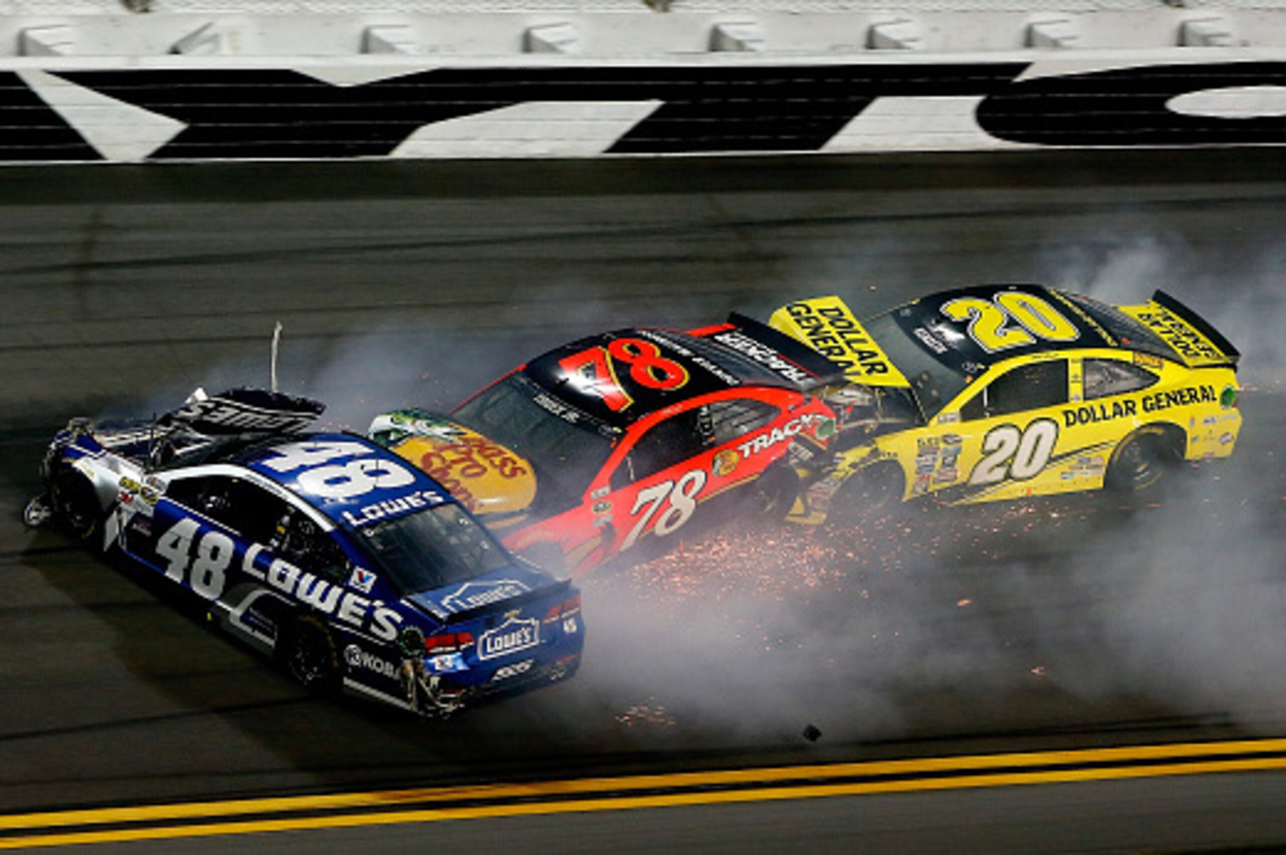 DAYTONA BEACH, FL - FEBRUARY 18:  Jimmie Johnson, driver of the #48 Lowe's Chevrolet, Martin Truex Jr., driver of the #78 Bass Pro Shops/Tracker Boats Toyota, and Matt Kenseth, driver of the #20 Dollar General Toyota, have an on track incident during the 