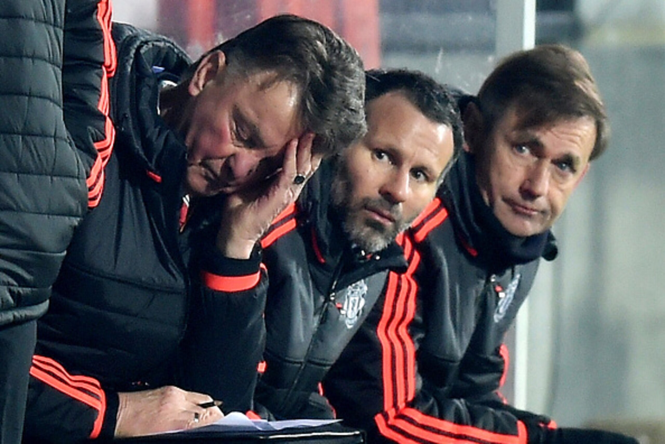 HERNING, DENMARK - FEBRUARY 18: Louis van Gaal (L) Manager of Manchester United scratches his head while Ryan Giggs (C) assistant manager looks on during the UEFA Europa League round of 32 first leg match between FC Midtjylland and Manchester United at H HERNING, DENMARK - FEBRUARY 18: Louis van Gaal (L) Manager of Manchester United scratches his head while Ryan Giggs (C) assistant manager looks on during the UEFA Europa League round of 32 first leg match between FC Midtjylland and Manchester United at H