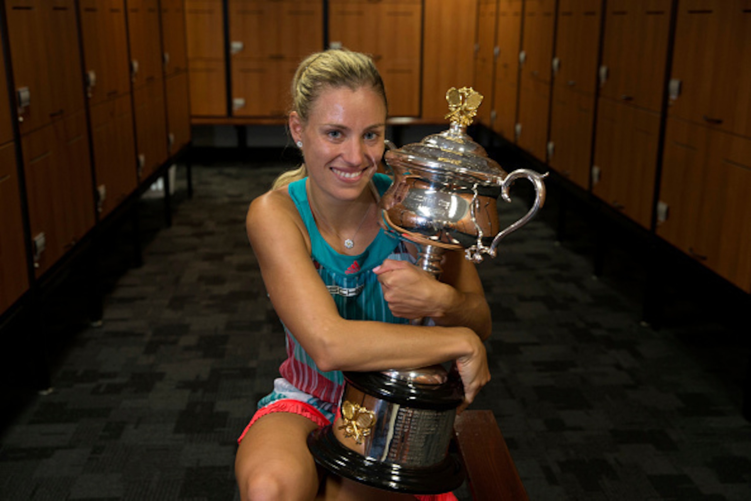 MELBOURNE, VICTORIA - JANUARY 30:  In this handout photo provided by Tennis Australia, Angelique Kerber of Germany poses with the Daphne Akhurst Trophy in the players change rooms after winning her Women's Singles Final match against Serena Williams of th