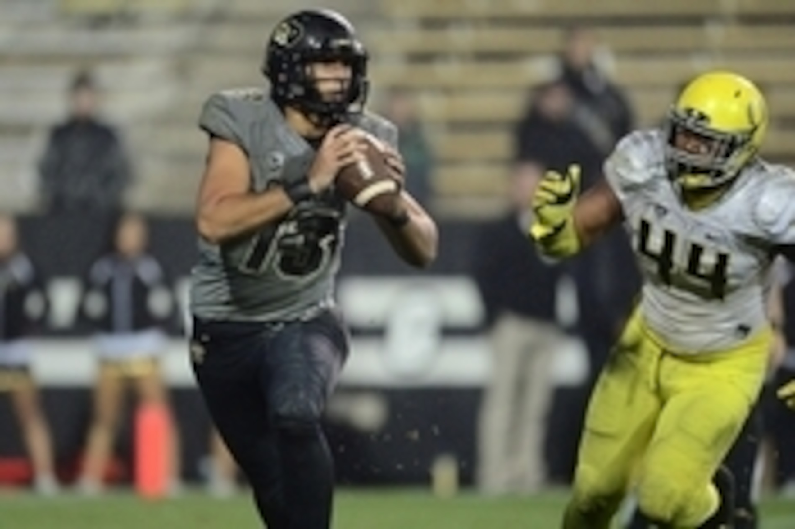 Oct 3, 2015; Boulder, CO, USA; Oregon Ducks defensive lineman DeForest Buckner (44) chases Colorado Buffaloes quarterback Sefo Liufau (13) late in the fourth quarter at Folsom Field. The Ducks defeated the Buffaloes 41-24. Mandatory Credit: Ron Chenoy-USA