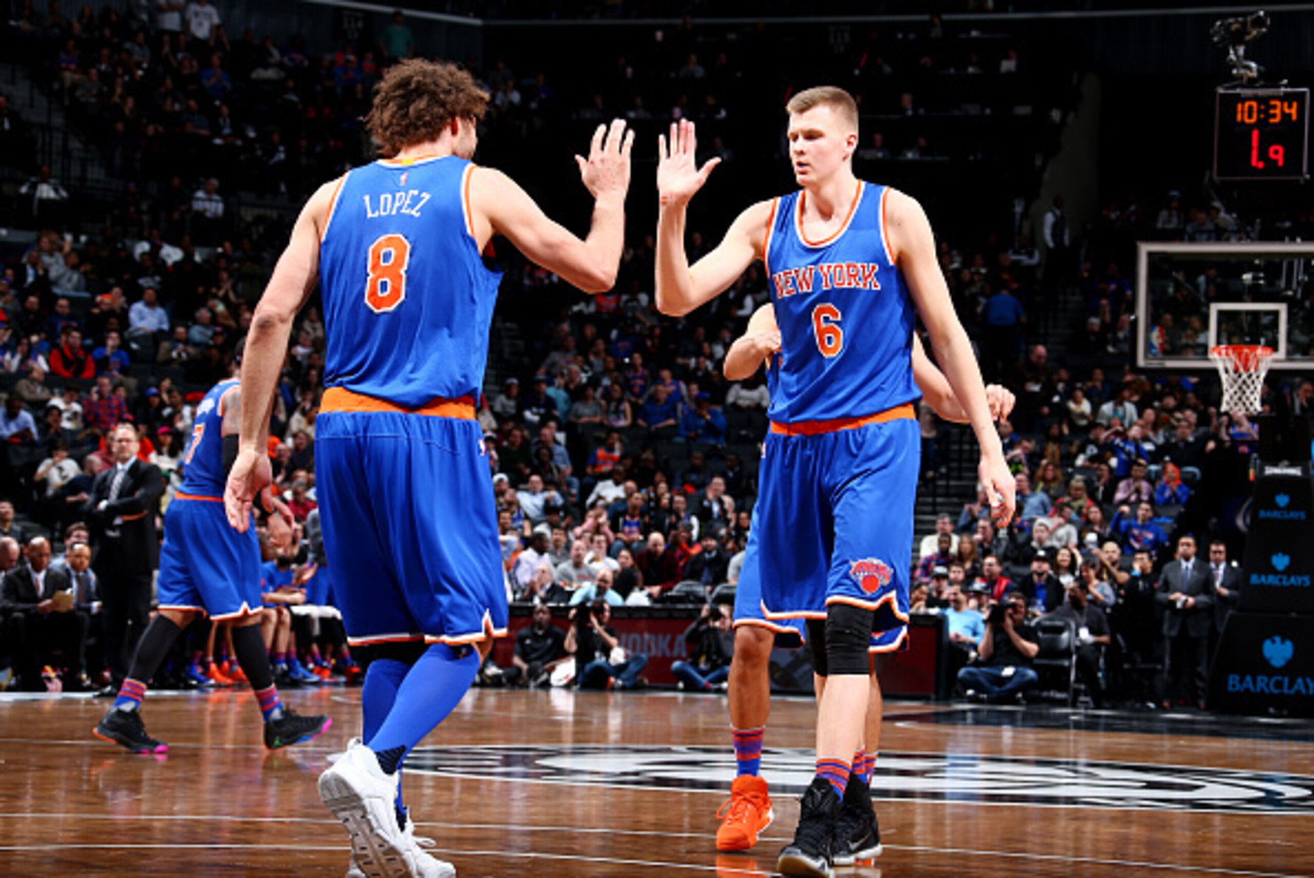 BROOKLYN, NY - FEBRUARY 19: Kristaps Porzingis #6 celebrates with Robin Lopez #8 of the New York Knicks against the Brooklyn Nets on February 19, 2016 at Barclays Center in Brooklyn, New York. NOTE TO USER: User expressly acknowledges and agrees that, by 